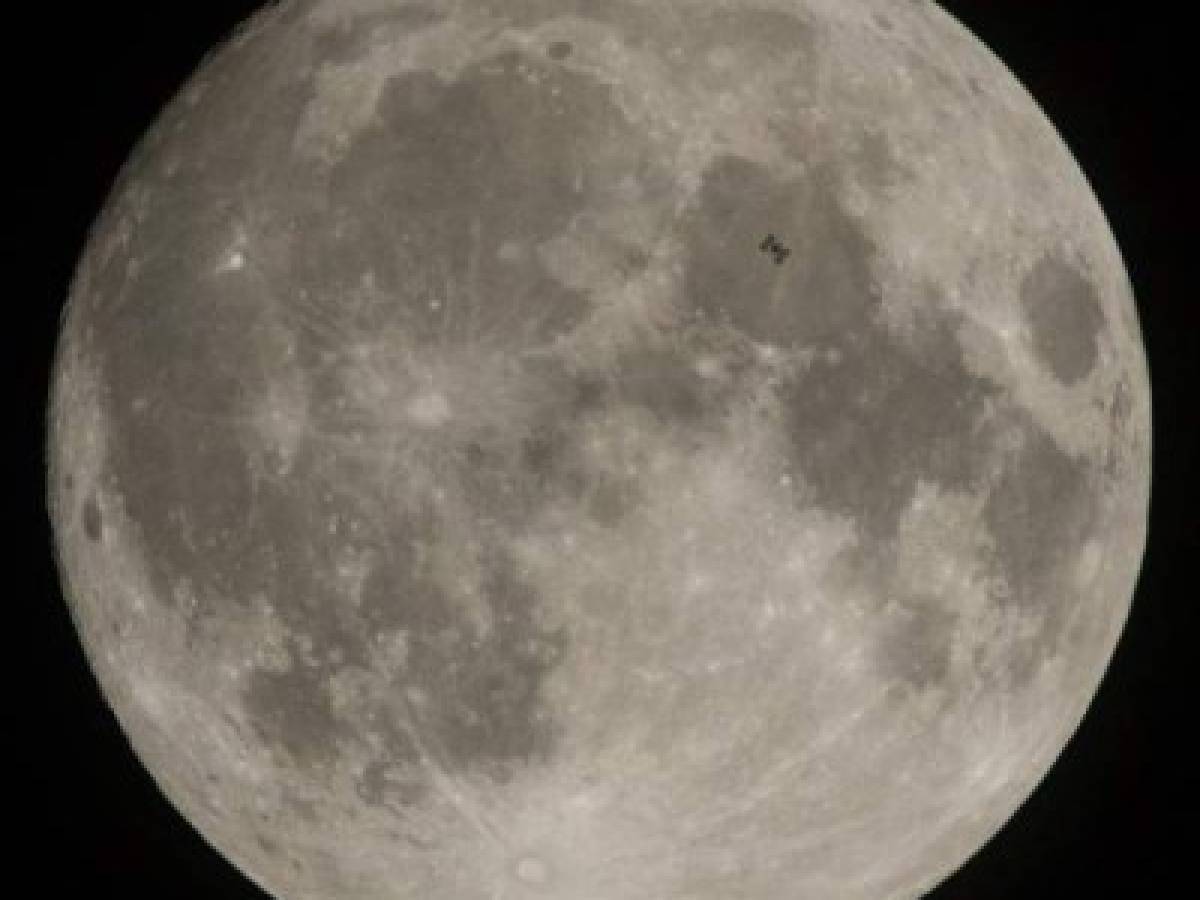 This NASA photo released December 4, 2017 shows the International Space Station, with a crew of six onboard, seen in silhouette as it transits the Moon at roughly five miles per second, on December 2, 2017, in Manchester Township, York County, Pennsylvania. Onboard are: NASA astronauts Joe Acaba, Mark Vande Hei, and Randy Bresnik; Russian cosmonauts Alexander Misurkin and Sergey Ryanzansky; and ESA astronaut Paolo Nespoli. / AFP PHOTO / NASA / Joel KOWSKY / RESTRICTED TO EDITORIAL USE - MANDATORY CREDIT 'AFP PHOTO / NASA/JOEL KOWSKY/HANDOUT' - NO MARKETING NO ADVERTISING CAMPAIGNS - DISTRIBUTED AS A SERVICE TO CLIENTS
