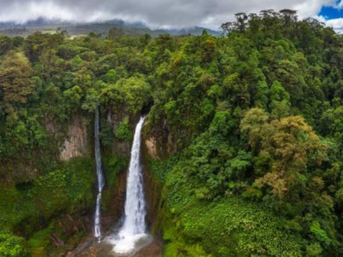 Aerial view of the Catarata del Toro waterfall in Costa Rica with surrounding mountains. This waterfall is located in Juan Castro Blanco National Park on the Toro Amarillo River and is 90m high. Aerial view of the Catarata del Toro waterfall in Costa Rica with surrounding mountains. This waterfall is located in Juan Castro Blanco National Park on the Toro Amarillo River and is 90m high.