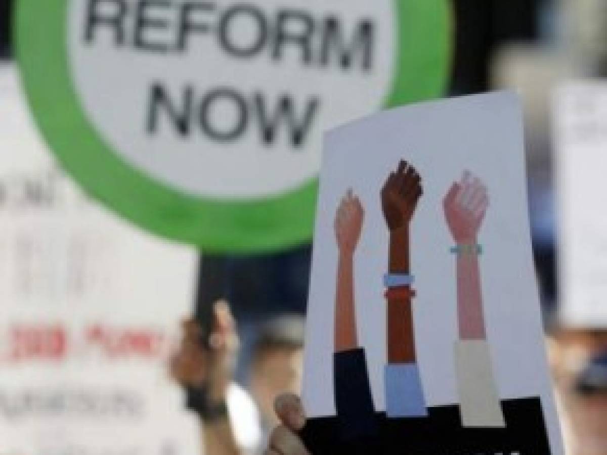 (FILES) In this file photo taken on February 17, 2018 Protesters hold signs at a rally for gun control at the Broward County Federal Courthouse in Fort Lauderdale, Florida.Students who survived a mass shooting at their Florida school on February 18, 2018 announced plans to march on Washington in a bid to 'shame' lawmakers into reforming laws that make powerful firearms readily available. The 'March for our Lives' will take place on March 24, with sister marches planned across the country, a group of students told ABC News, vowing to make Wednesday's shooting a turning point in America's deadlocked debate on gun control. / AFP PHOTO / RHONA WISE