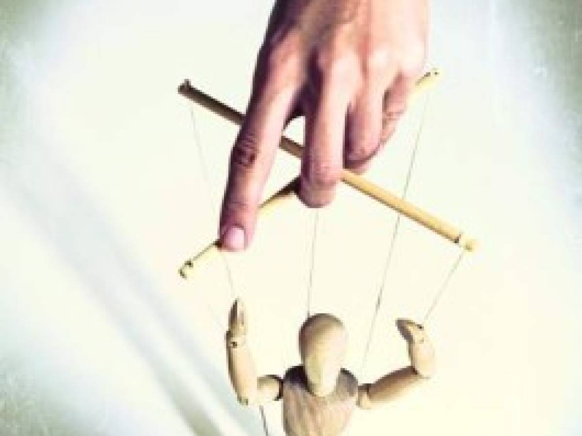 Hand manipulating a puppet on a dark background scratched Hand manipulating a puppet on a dark background scratched