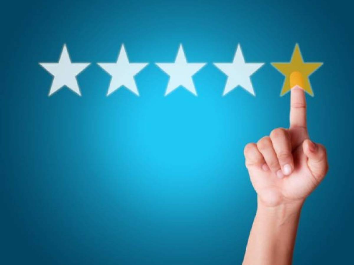 Businesswoman touching five star symbol to increase rating of company