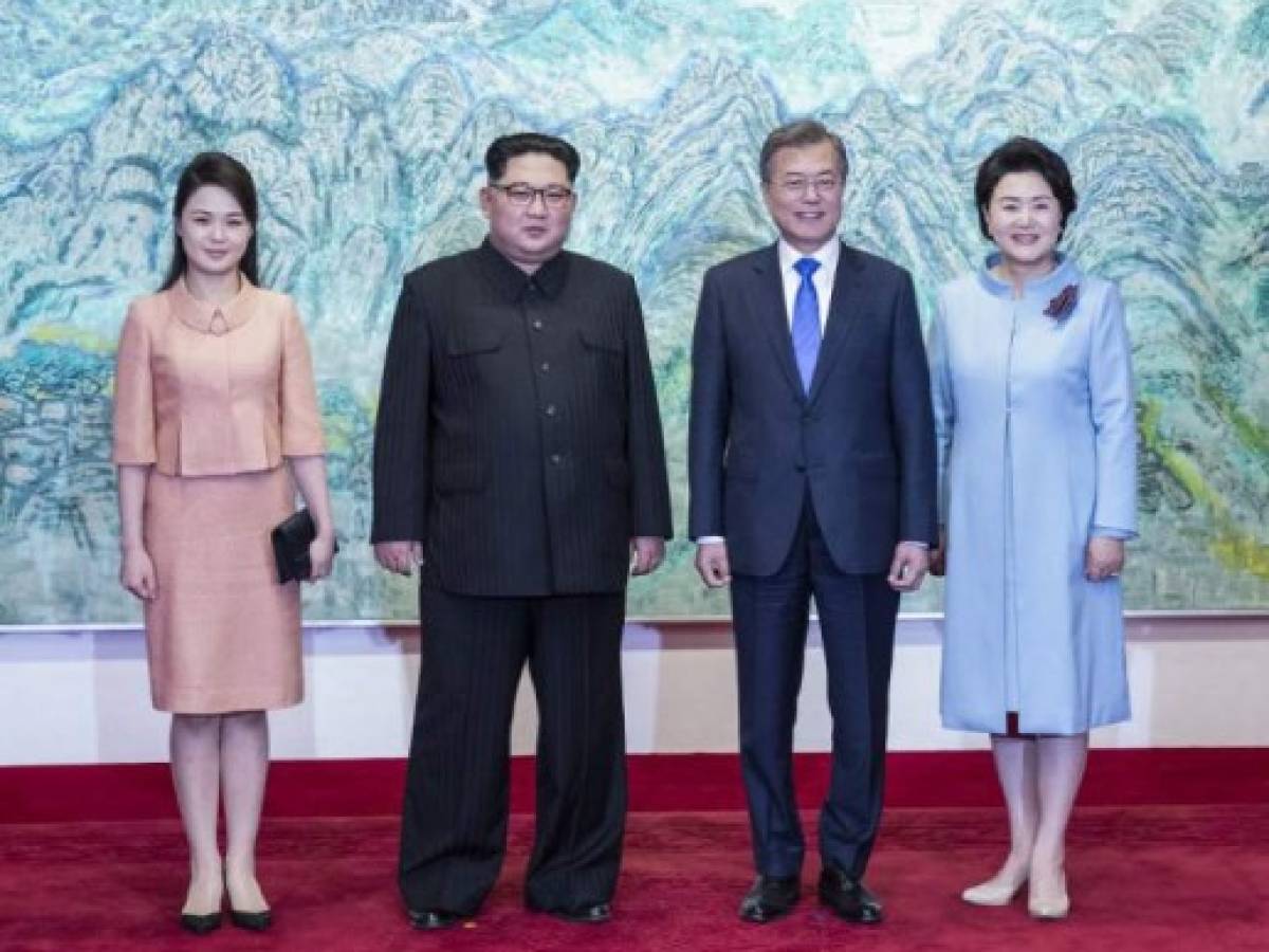 North Korea's leader Kim Jong Un (2nd L) and his wife Ri Sol Ju (L) pose for a photo with South Korea's President Moon Jae-in (2nd R) and his wife Kim Jung-sook (R) at the end of their historic summit at the truce village of Panmunjom on April 27, 2018.The leaders of the two Koreas held a landmark summit on April 27 after a highly symbolic handshake over the Military Demarcation Line that divides their countries, with the North's Kim Jong Un declaring they were at the 'threshold of a new history'. / AFP PHOTO / Korea Summit Press Pool / Korea Summit Press Pool North Korea's leader Kim Jong Un (2nd L) and his wife Ri Sol Ju (L) pose for a photo with South Korea's President Moon Jae-in (2nd R) and his wife Kim Jung-sook (R) at the end of their historic summit at the truce village of Panmunjom on April 27, 2018.The leaders of the two Koreas held a landmark summit on April 27 after a highly symbolic handshake over the Military Demarcation Line that divides their countries, with the North's Kim Jong Un declaring they were at the 'threshold of a new history'. / AFP PHOTO / Korea Summit Press Pool / Korea Summit Press Pool