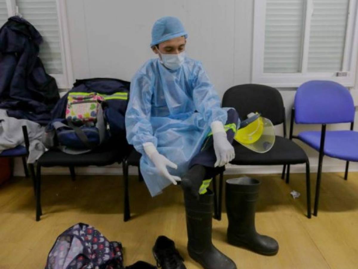 Los paramédicos se preparan para su turno en la ciudad de Panamá el 14 de diciembre de 2020.- Un grupo de paramédicos de la Caja del Seguro Social (CSS) fueron asignados durante la pandemia para atender a los pacientes infectados por Covid-19, brindando atención prehospitalaria y traslados ellos a diferentes hospitales. (Foto de STR / AFP)