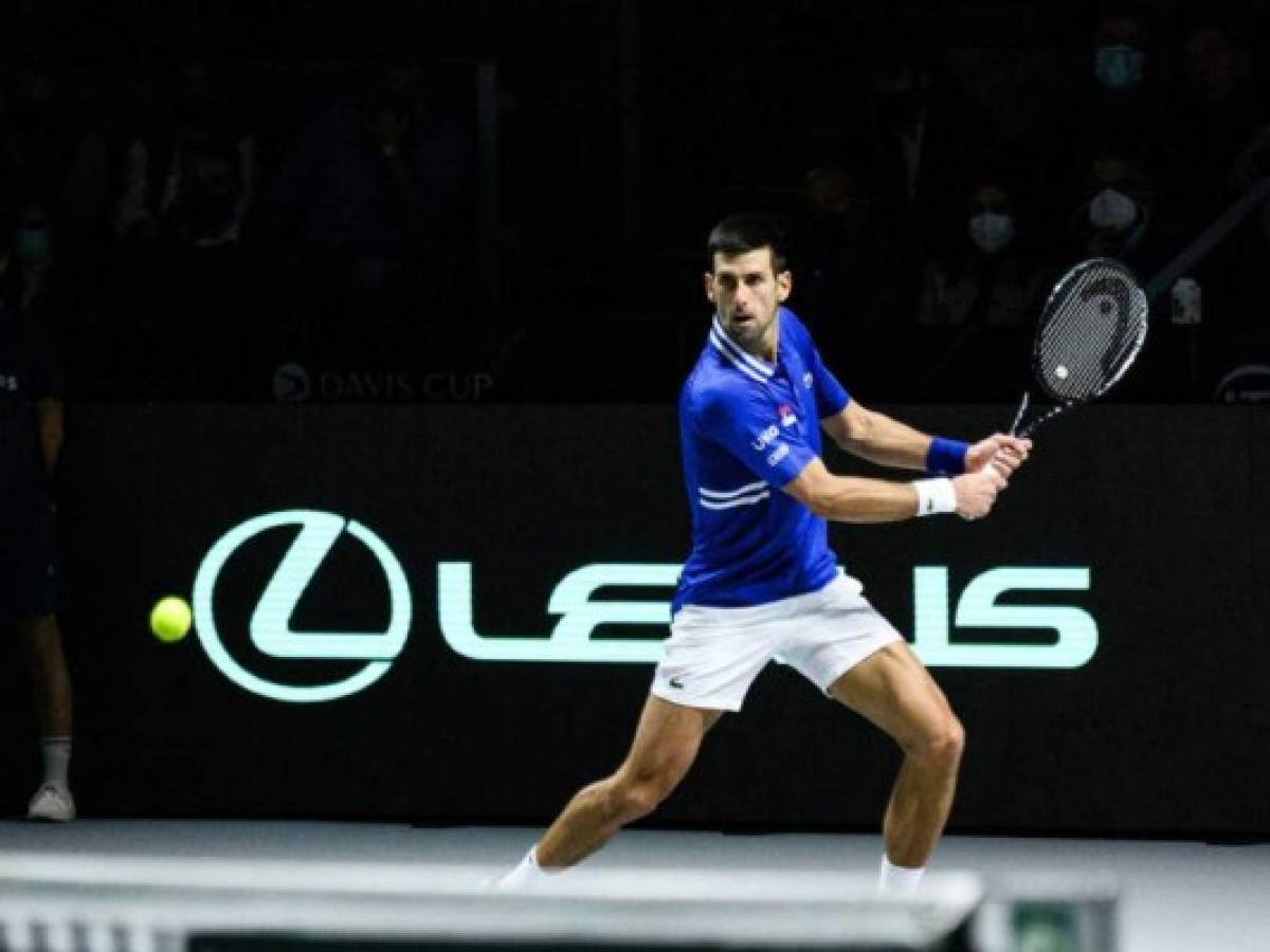 MADRID, SPAIN - DECEMBER 03: (EDITORIAL USE ONLY) Novak Djokovic of Serbia plays a backhand against Marin Cilic of Croatia during the Davis Cup Semi Final match between Croatia and Serbia at Madrid Arena pavilion on December 03, 2021 in Madrid, Spain. (Photo by Juan Naharro Gimenez/Getty Images for Lexus)