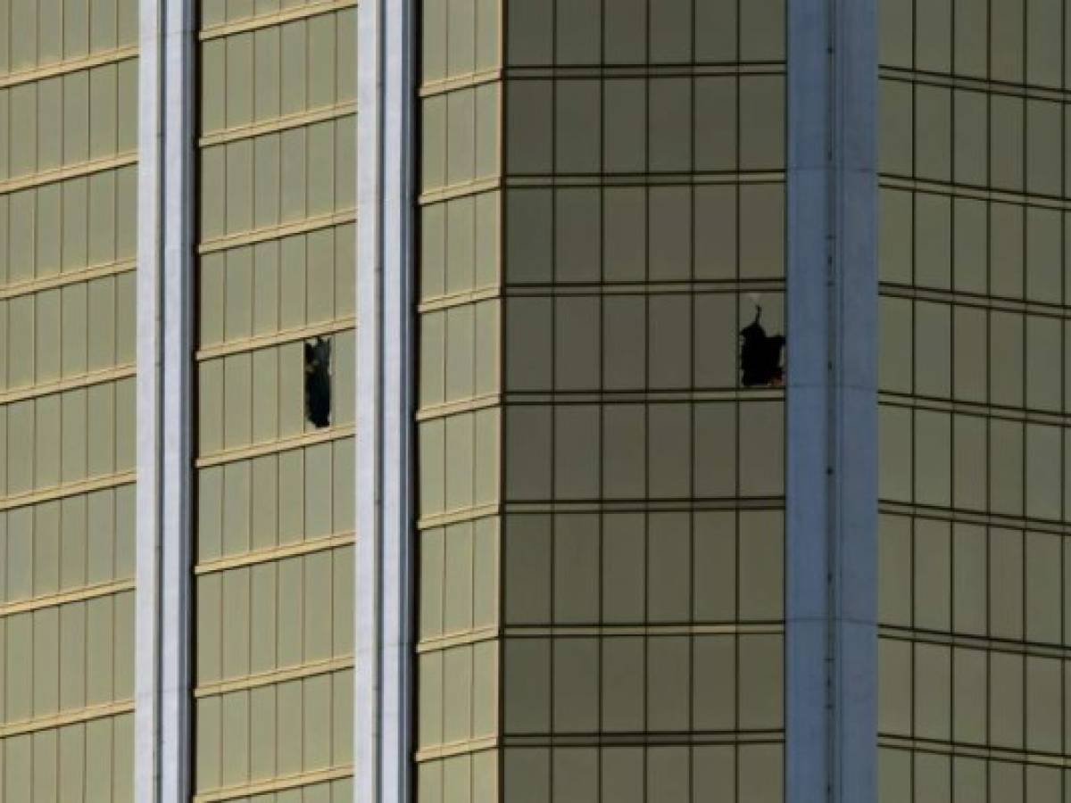 The damaged windows on the 32nd floor room that was used by the shooter in the Mandalay Hotel after a gunman killed at least 58 people and wounded more than 500 others when he opened fire on a country music concert in Las Vegas, Nevada on October 2, 2017. Police said the gunman, a 64-year-old local resident named as Stephen Paddock, had been killed after a SWAT team responded to reports of multiple gunfire from the 32nd floor of the Mandalay Bay, a hotel-casino next to the concert venue. / AFP PHOTO / Mark RALSTON The damaged windows on the 32nd floor room that was used by the shooter in the Mandalay Hotel after a gunman killed at least 58 people and wounded more than 500 others when he opened fire on a country music concert in Las Vegas, Nevada on October 2, 2017. Police said the gunman, a 64-year-old local resident named as Stephen Paddock, had been killed after a SWAT team responded to reports of multiple gunfire from the 32nd floor of the Mandalay Bay, a hotel-casino next to the concert venue. / AFP PHOTO / Mark RALSTON