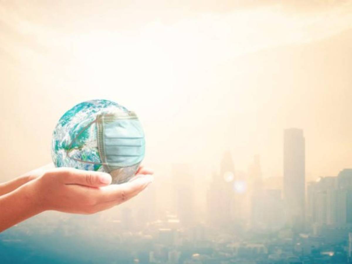 Human hands holding earth globe with medical disposable face mask. Elements of this image furnished by NASA Human hands holding earth globe with medical disposable face mask. Elements of this image furnished by NASA