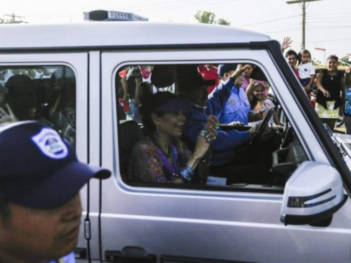 Nicaragua's President Daniel Ortega (R) and his wife, Vice-President Rosario Murillo, gesture at the crowd during the inauguration of the Nejapa flyover in Managua on March 21, 2019. - Nicaragua's government and opposition delegations resumed stalled peace talks Thursday aimed at ending a deadly 11-month political crisis. The resumption follows an agreement on Wednesday by the government of President Daniel Ortega to release all opposition prisoners within 90 days. (Photo by Maynor Valenzuela / AFP)