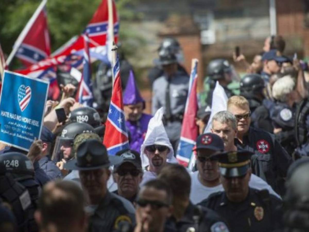 (FILES) This file photo taken on July 08, 2017 shows members of the Ku Klux Klan and others arriving for a rally, calling for the protection of Southern Confederate monuments, in Charlottesville, Virginia.A sizeable contingent of members of the extreme right and white nationalists are expected to descend on a small US university town on August 12, 2017 -- and a fierce opposition front is uniting against it.Thousands of white nationalists, including supporters of the Ku Klux Klan white supremacist group, and anti-fascist activists are expected to clash in Charlottesville, Virginia, a sleepy town planning to remove a statue of General Robert E. Lee, who led Confederate forces in the US Civil War. / AFP PHOTO / ANDREW CABALLERO-REYNOLDS