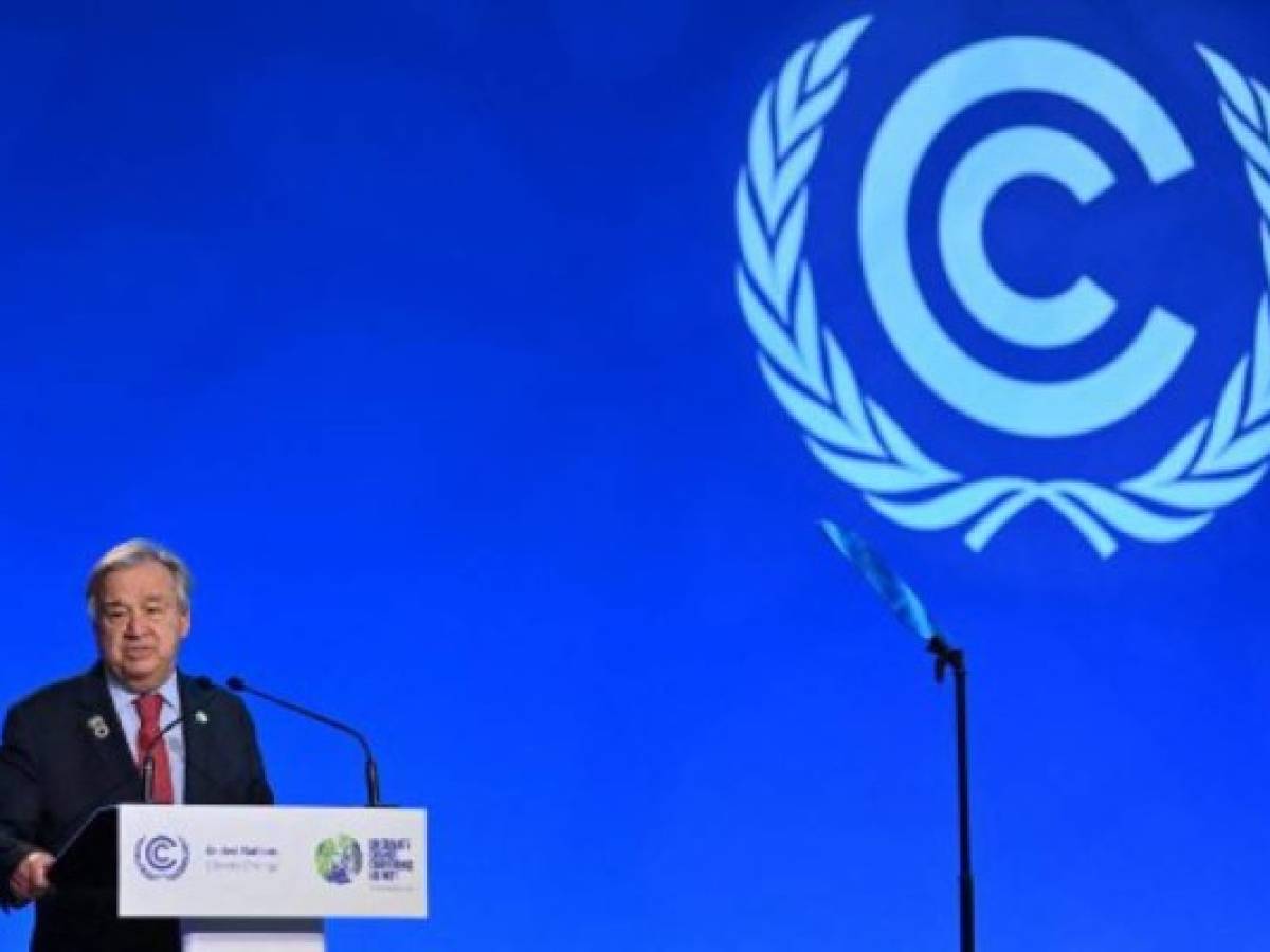 (FILES) In this file photo taken on November 11, 2021 United Nations (UN) Secretary General Antonio Guterres speaks during an plenary session at the COP26 UN Climate Change Conference in Glasgow. - UN chief Antonio Guterres said the world was still on the precipice of 'catastrophe' after nations reached a global climate deal Saturday that fell short of what science says is needed to contain dangerous warming. 'Our fragile planet is hanging by a thread,' Guterres said in a statement that welcomed progress at the Glasgow summit, while stressing it was 'not enough'.'We are still knocking on the door of climate catastrophe,' he added. (Photo by Paul ELLIS / AFP)