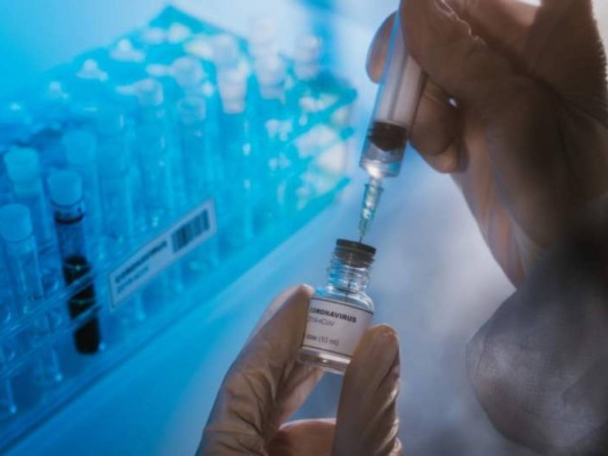 Doctor preparing the coronavirus COVID-19 vaccine. Details of hands and syringe.