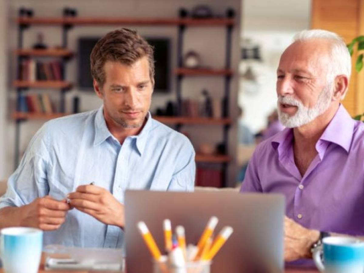 Two businessmen working together on new project in modern office.