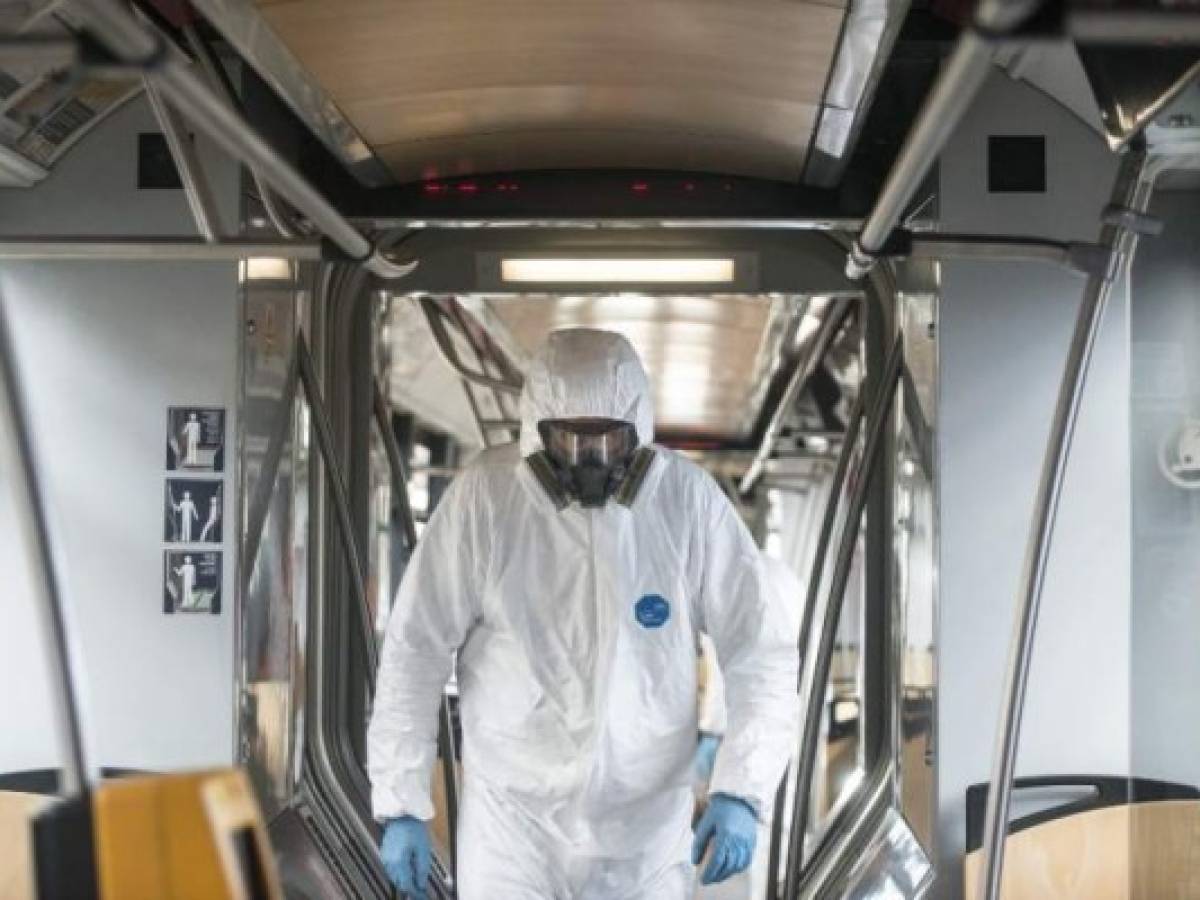 A worker walks in a tram during a test of new nano polymer disinfection as part of precautionary measures against the spread of the new coronavirus COVID-19 on March 12, 2020 in Prague. - Czech Ministry of Health confirmed 94 cases of Covid -19 on March 11, 2020 in the Czech Republic . (Photo by Michal Cizek / AFP) A worker walks in a tram during a test of new nano polymer disinfection as part of precautionary measures against the spread of the new coronavirus COVID-19 on March 12, 2020 in Prague. - Czech Ministry of Health confirmed 94 cases of Covid -19 on March 11, 2020 in the Czech Republic . (Photo by Michal Cizek / AFP)