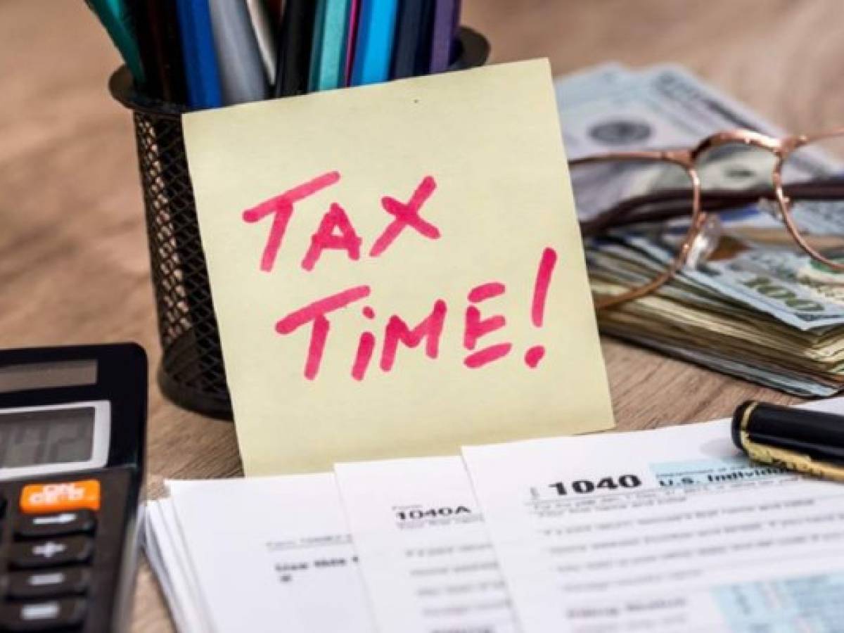 tax form with calculator, money and pen tax form with calculator, money and pen