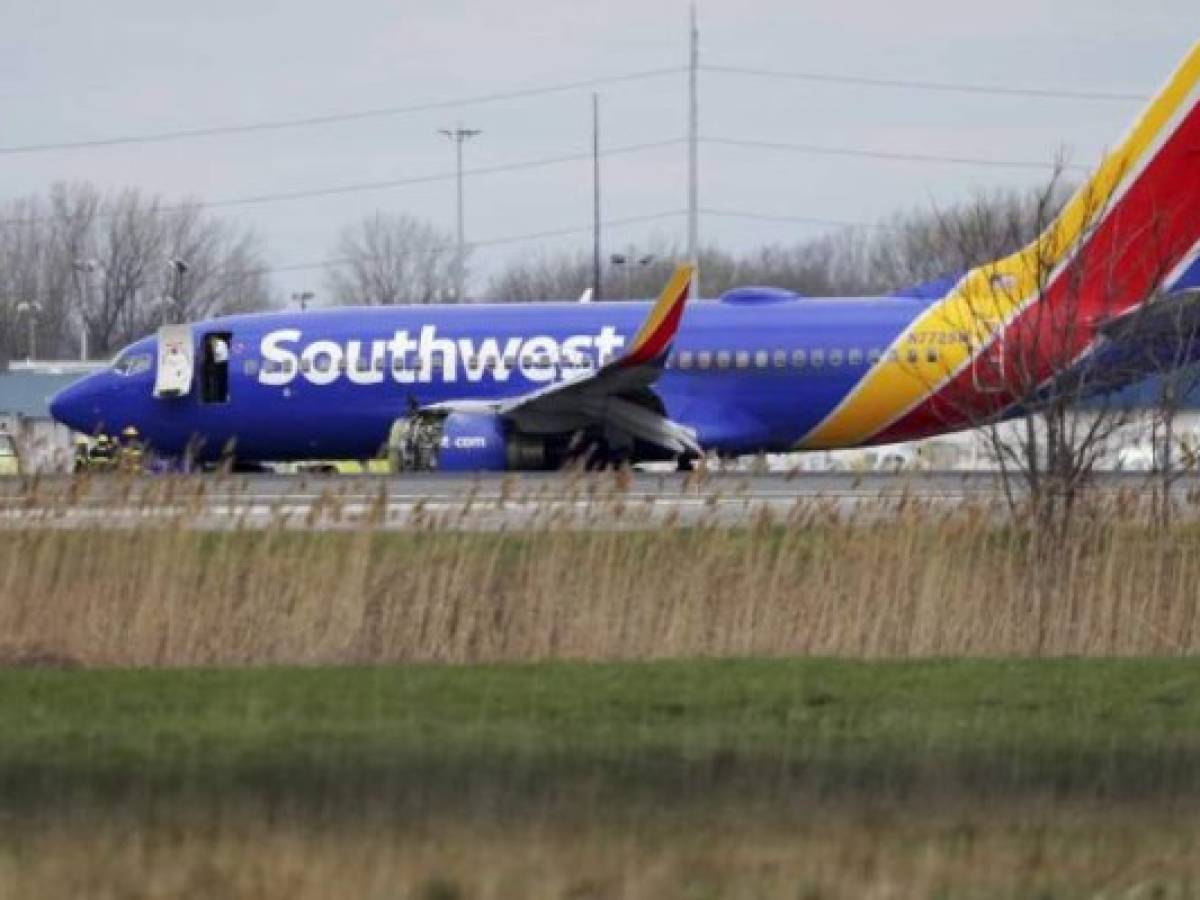 This photo obtained April 18, 2018 courtesy of the National Transportation Safety Board shows NTSB investigators on scene examining damage to the engine of the Southwest Airlines plane on April 17, 2018.Catastrophic engine failure on a Southwest Airlines flight from New York to Dallas killed a mother-of-two and forced an emergency landing April 17, 2018, the first fatal incident in US commercial aviation for nearly a decade.The Boeing 737-700 took off without incident but minutes into the flight, passengers heard an explosion in the left engine, which sent shrapnel flying through the window, shattering the glass and leading oxygen masks to drop, witnesses said. / AFP PHOTO / National Transportation Safety Board / Handout / RESTRICTED TO EDITORIAL USE - MANDATORY CREDIT 'AFP PHOTO / NATIONAL TRANSPORTATION SAFETY BOARD/HANDOUT' - NO MARKETING NO ADVERTISING CAMPAIGNS - DISTRIBUTED AS A SERVICE TO CLIENTS This photo obtained April 18, 2018 courtesy of the National Transportation Safety Board shows NTSB investigators on scene examining damage to the engine of the Southwest Airlines plane on April 17, 2018.Catastrophic engine failure on a Southwest Airlines flight from New York to Dallas killed a mother-of-two and forced an emergency landing April 17, 2018, the first fatal incident in US commercial aviation for nearly a decade.The Boeing 737-700 took off without incident but minutes into the flight, passengers heard an explosion in the left engine, which sent shrapnel flying through the window, shattering the glass and leading oxygen masks to drop, witnesses said. / AFP PHOTO / National Transportation Safety Board / Handout / RESTRICTED TO EDITORIAL USE - MANDATORY CREDIT 'AFP PHOTO / NATIONAL TRANSPORTATION SAFETY BOARD/HANDOUT' - NO MARKETING NO ADVERTISING CAMPAIGNS - DISTRIBUTED AS A SERVICE TO CLIENTS
