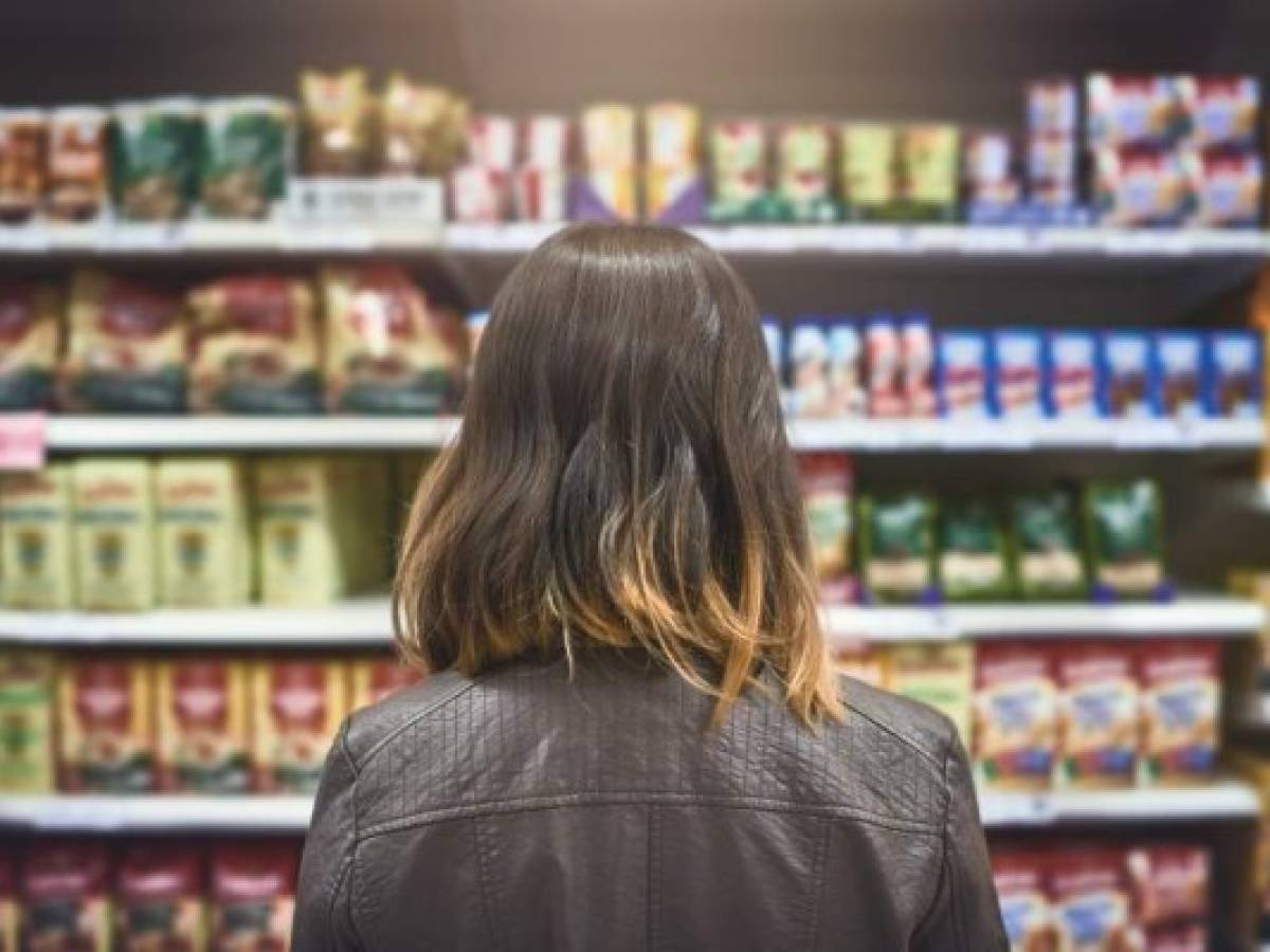 Rearview shot of a young woman shopping at a grocery store