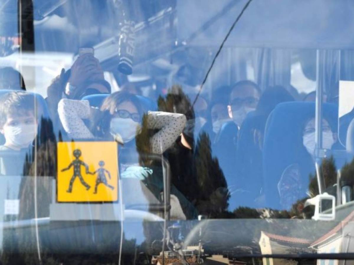 A vehicle believed to contain French citizens after their evacuation from the Chinese city of Wuhan, arrives at The Vacanciel Holiday Resort in Carry-le-Rouet, near Marseille, southern France on January 31, 2020, following their repatriation from the coronavirus zone. - A plane carrying around 200 French citizens evacuated from the Chinese city of Wuhan, epicentre of the coronavirus outbreak, landed near Marseille, AFP reporters onboard the aircraft said. The passengers, who will be placed in quarantine at a seaside holiday camp for two weeks, applauded as the plane touched down at the Istres military base. None have shown any symptoms of the virus that has killed 213 people and infected nearly 10,000 in mainland China, prompting the World Health Organization to declare a global emergency. (Photo by GERARD JULIEN / AFP)