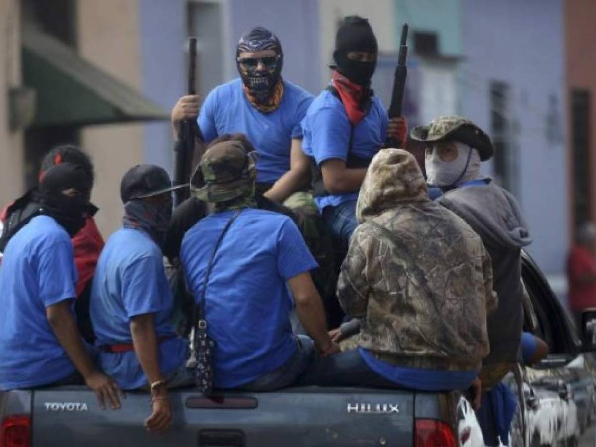 Paramilitaries are seen on trucks at Monimbo neighborhood in Masaya, Nicaragua, on July 18, 2018, following clashes with anti-government demonstrators.The head of the Inter-American Commission on Human Rights has described as 'alarming' the ongoing violence in Nicaragua, where months of clashes between protesters and the forces of President Daniel Ortega have claimed almost 300 lives. / AFP PHOTO / MARVIN RECINOS