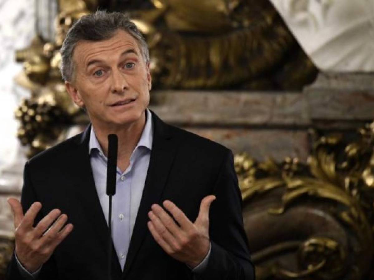 (FILES) In this file photo taken on June 21, 2018 Argentine President Mauricio Macri speaks during the swearing-in ceremony of his new Energy Minister Javier Iguacel and Production Minister Dante Sica (out of frame) at the Casa Rosada government palace in Buenos Aires.President Mauricio Macri said September 24, 2018 that crisis-hit Argentina will receive additional funding from the International Monetary Fund and vowed to avoid a default. 'We are going to have more support from the IMF, although I cannot say how much because negotiations are ongoing,' said Macri, whose government agreed on a three-year, $50 billion rescue lending program with the IMF in June. / AFP PHOTO / EITAN ABRAMOVICH (FILES) In this file photo taken on June 21, 2018 Argentine President Mauricio Macri speaks during the swearing-in ceremony of his new Energy Minister Javier Iguacel and Production Minister Dante Sica (out of frame) at the Casa Rosada government palace in Buenos Aires.President Mauricio Macri said September 24, 2018 that crisis-hit Argentina will receive additional funding from the International Monetary Fund and vowed to avoid a default. 'We are going to have more support from the IMF, although I cannot say how much because negotiations are ongoing,' said Macri, whose government agreed on a three-year, $50 billion rescue lending program with the IMF in June. / AFP PHOTO / EITAN ABRAMOVICH