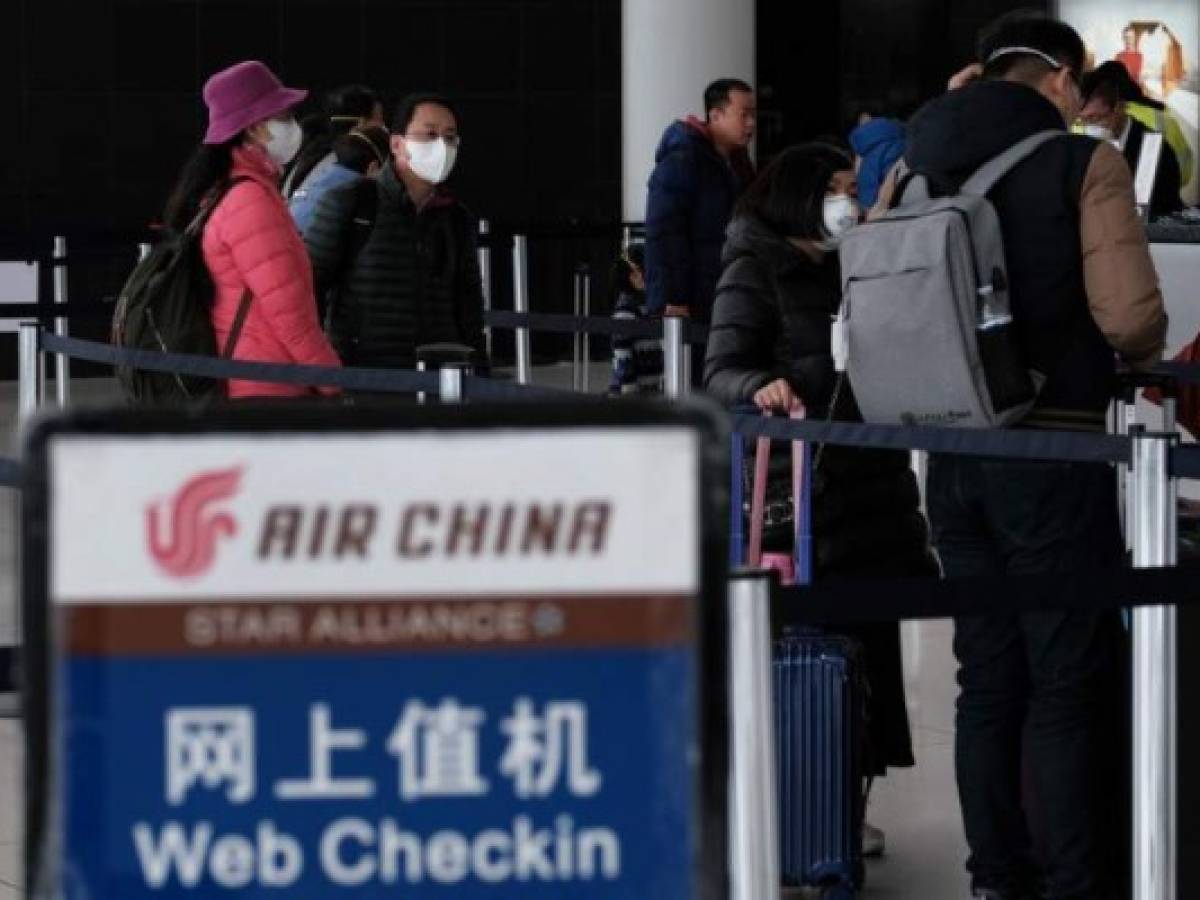 NEW YORK, NEW YORK - JANUARY 31: At the terminal that serves planes bound for China, people wear medical masks at John F. Kennedy Airport (JFK) out of concern over the Coronavirus on January 31, 2020 in New York City. The virus, which has so far killed over 200 people and infected an estimated 9,900 people, is believed to have started in the Chinese city of Wuhan. Spencer Platt/Getty Images/AFP