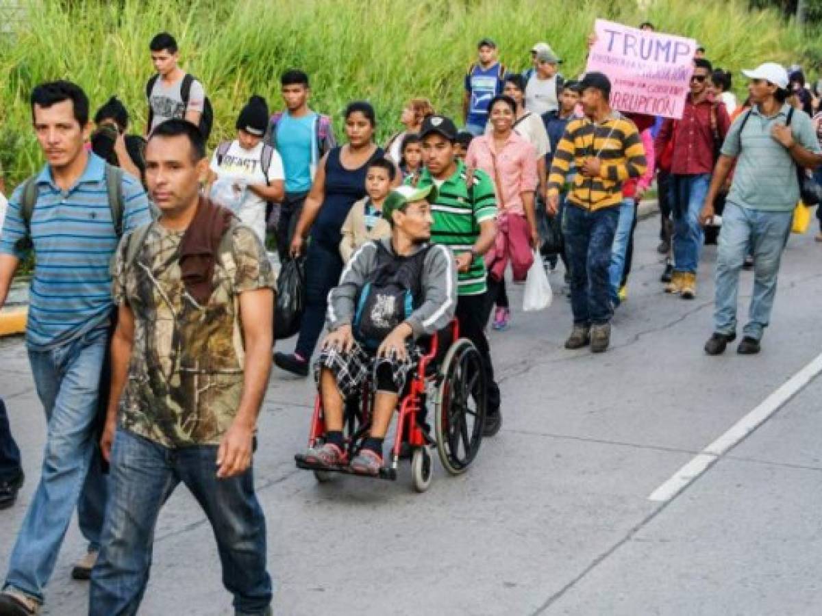 Hondurans walk towards the US from San Pedro Sula, 180 kms north from Tegucigalpa, on October 13, 2018. - Hondurans decided to left their country due to insecurity and the lack of employment opportunities. The exodus started from the bus station in San Pedro Sula towards the border with Guatemala. (Photo by ORLANDO SIERRA / AFP)