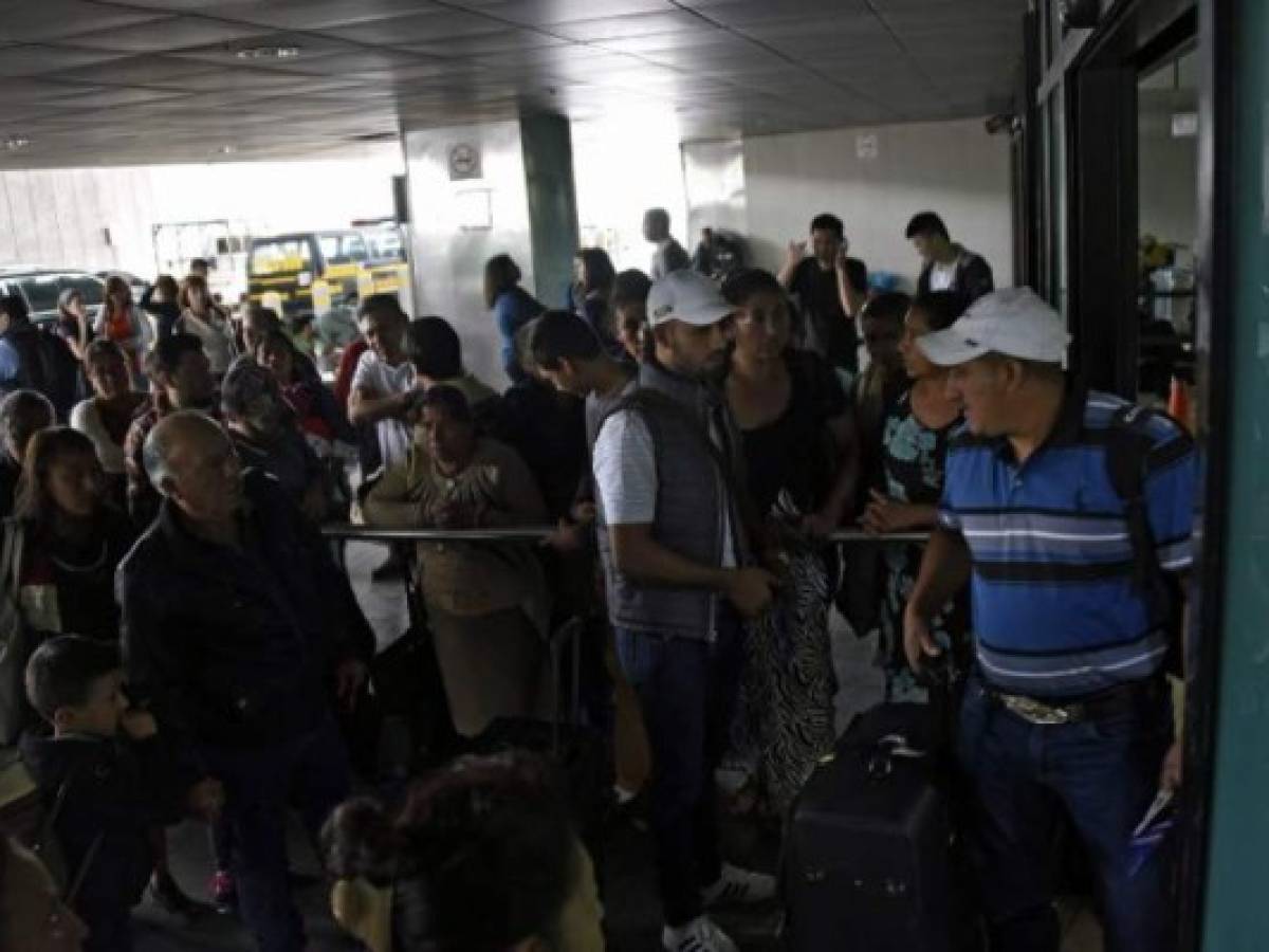 People are seen outside the La Aurora international airport, which remains closed due to the ash that fell after the eruption of the volcano, in Guatemala City on June 3, 2018. / AFP PHOTO / JOHAN ORDONEZ