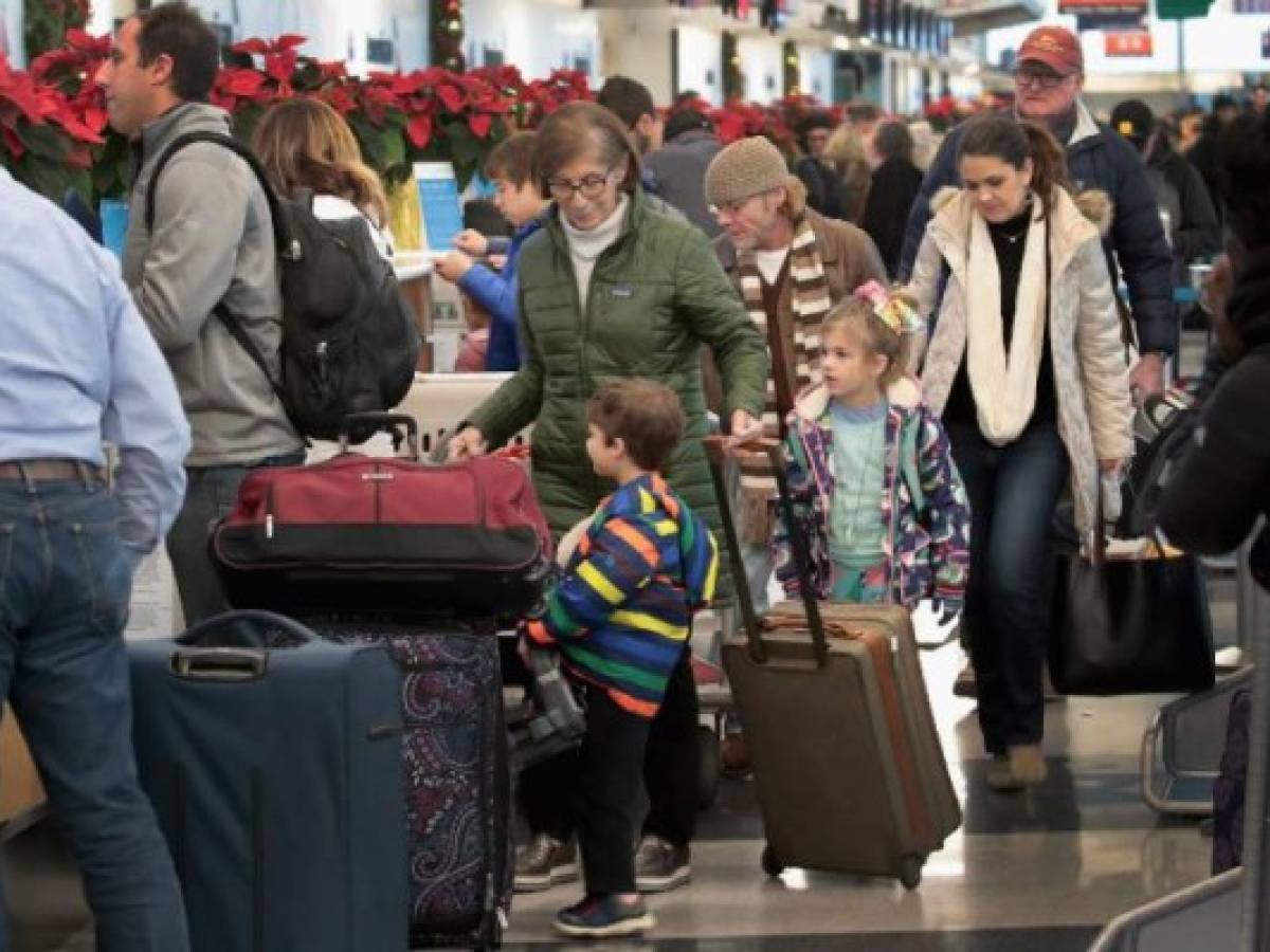 CHICAGO, IL - NOVEMBER 26: Passengers try to catch flights out of O'Hare International Airport after an early winter snowstorm caused the delay and cancellation of hundreds of flights at the airport on November 26, 2018 in Chicago, Illinois. The storm, which dumped upwards to a foot of snow in Chicago and the surrounding area, also caused scores of traffic accidents and left thousands without power. Scott Olson/Getty Images/AFP