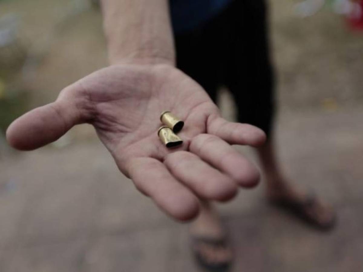 A protester shows bullet cases after the Upoli University was attacked last night during the recent protests following an attempt by President Daniel Ortega to reform the near-bankrupt social security system, at the Upoli University in Managua on May 11, 2018 The wave of anti-Ortega unrest which broke out in mid-April was triggered by an aborted attempt to reform the near-bankrupt social security system, but quickly expanded to include a wave of grievances against the president, including claims of corruption and repression. / AFP PHOTO / DIANA ULLOA