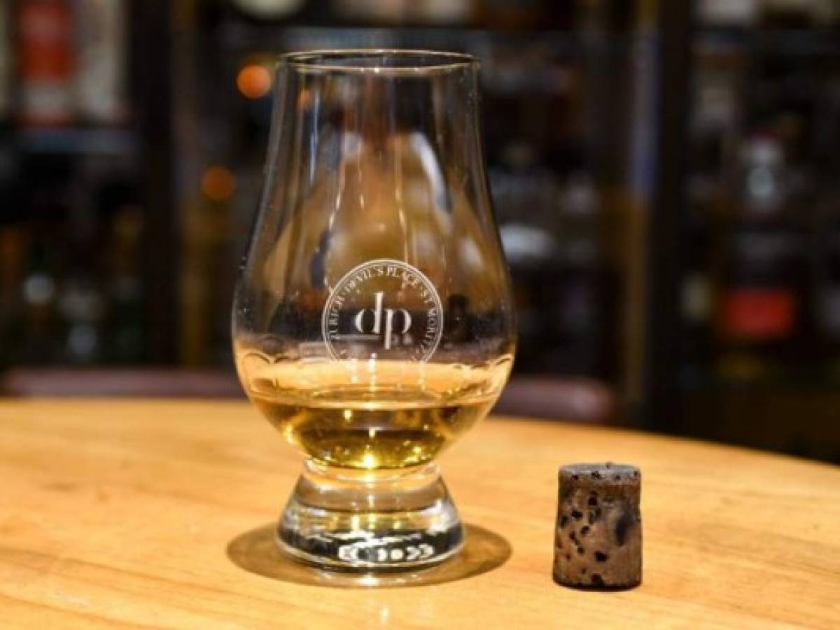(FILES) This file handout photo taken and released on August 2, 2017 by the Hotel Waldhaus am See in St. Moritz shows a glass of whisky from a bottle labeled to be made in 1878 by the revered Scotch maker Macallan, at the hotel's Devil's Place Whisky Bar.The shot of Macallan whisky purportedly made in 1878 that a Chinese man paid 10,000 USD for at a Swiss hotel was actually distilled between 1970 and 1972, local media reported on November 2, 2017. In August, the young customer entered the Devil's Place Whisky Bar at the luxury Waldhaus Hotel in St. Moritz, northeast Switzerland, and expressed particular interest in rare Macallans. The customer chose the bottled marked as an 1878 vintage, which went for 9,999 Swiss francs ($10,000, 8,500 euros) for a two-centilitre (0.66-fluid-ounce) measure. / AFP PHOTO / Hotel Waldhaus am See / HANDOUT / RESTRICTED TO EDITORIAL USE - MANDATORY CREDIT 'AFP PHOTO / WALDHAUS AM SEE HOTEL' - NO MARKETING NO ADVERTISING CAMPAIGNS - DISTRIBUTED AS A SERVICE TO CLIENTS (FILES) This file handout photo taken and released on August 2, 2017 by the Hotel Waldhaus am See in St. Moritz shows a glass of whisky from a bottle labeled to be made in 1878 by the revered Scotch maker Macallan, at the hotel's Devil's Place Whisky Bar.The shot of Macallan whisky purportedly made in 1878 that a Chinese man paid 10,000 USD for at a Swiss hotel was actually distilled between 1970 and 1972, local media reported on November 2, 2017. In August, the young customer entered the Devil's Place Whisky Bar at the luxury Waldhaus Hotel in St. Moritz, northeast Switzerland, and expressed particular interest in rare Macallans. The customer chose the bottled marked as an 1878 vintage, which went for 9,999 Swiss francs ($10,000, 8,500 euros) for a two-centilitre (0.66-fluid-ounce) measure. / AFP PHOTO / Hotel Waldhaus am See / HANDOUT / RESTRICTED TO EDITORIAL USE - MANDATORY CREDIT 'AFP PHOTO / WALDHAUS AM SEE HOTEL' - NO MARKETING NO ADVERTISING CAMPAIGNS - DISTRIBUTED AS A SERVICE TO CLIENTS