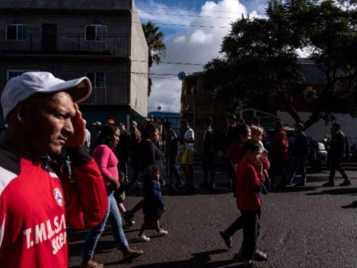 Central American migrants - mostly from Honduras - moving towards the United States, outside a shelter near the US-Mexico border fence in Tijuana, Baja California state, Mexico, on November 22, 2018. - US President Trump has sent about 5,800 troops to the border to forestall the arrival of large groups of Central American migrants traveling through Mexico and towards the US, in a move critics decry as a costly political stunt to galvanize supporters ahead of midterm elections earlier this month. (Photo by Guillermo Arias / AFP)