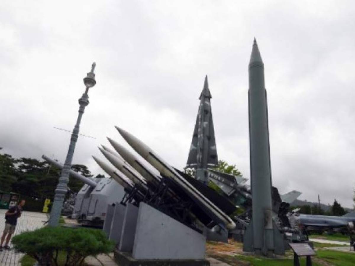 A man looks at replicas of a North Korean Scud-B missile (R) and South Korean missiles at the Korean War Memorial in Seoul on August 10, 2017.Nuclear-armed North Korea mocked President Donald Trump as 'bereft of reason' on August 10, raising the stakes in their stand-off with an unusually detailed plan to send a salvo of missiles towards the US territory of Guam. / AFP PHOTO / JUNG Yeon-Je