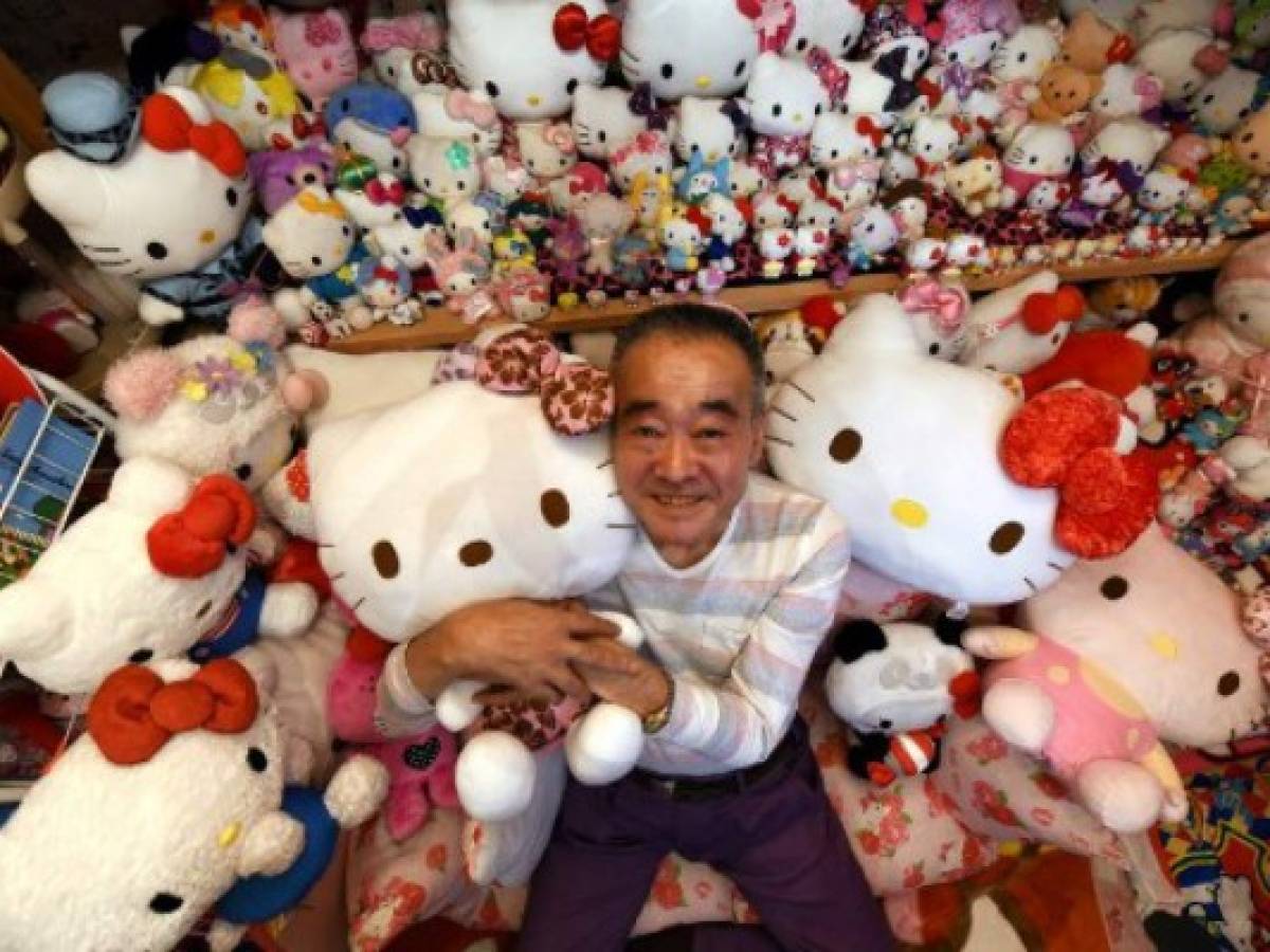This photo taken on June 28, 2017 shows retired Japanese police officer Masao Gunji posing with his Hello Kitty collection at his pink-painted Hello Kitty house in Yotsukaido, Chiba prefecture.Gunji was recognised for the largest Hello Kitty collection (5,169 items) by the Guinness World Records in November 2016. / AFP PHOTO / AFPBB News / Yoko AKIYOSHI / - Japan OUT / -----EDITORS NOTE --- RESTRICTED TO EDITORIAL USE - MANDATORY CREDIT 'AFP PHOTO / Yoko AKIYOSHI' - NO MARKETING - NO ADVERTISING CAMPAIGNS - DISTRIBUTED AS A SERVICE TO CLIENTS