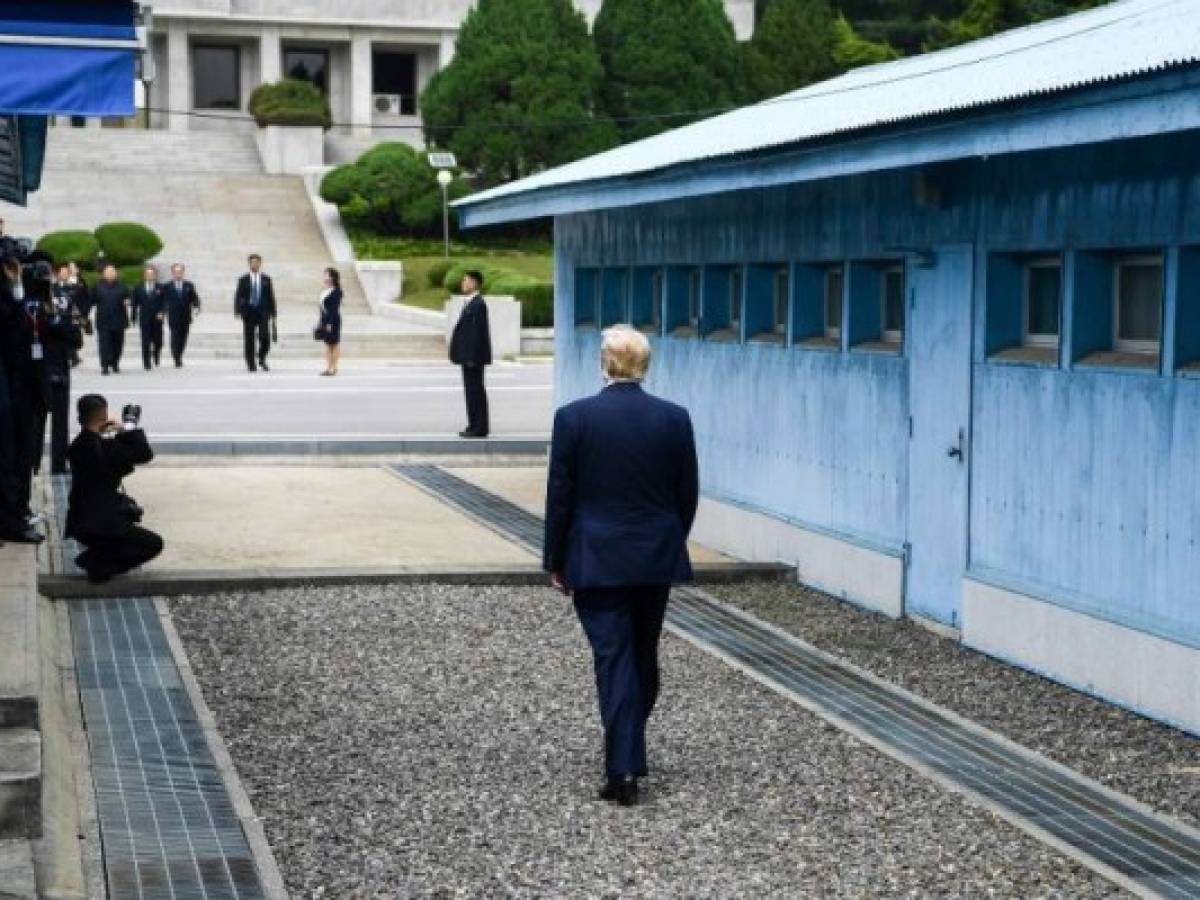 US President Donald Trump walks towards the Military Demarcation Line that divides North and South Korea, for a meeting with North Korea's leader Kim Jong Un, in the Joint Security Area (JSA) of Panmunjom in the Demilitarized zone (DMZ) on June 30, 2019. (Photo by Brendan Smialowski / AFP) US President Donald Trump walks towards the Military Demarcation Line that divides North and South Korea, for a meeting with North Korea's leader Kim Jong Un, in the Joint Security Area (JSA) of Panmunjom in the Demilitarized zone (DMZ) on June 30, 2019. (Photo by Brendan Smialowski / AFP)