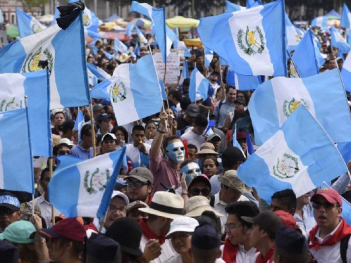 People from different social sectors gather at Constitution Square in front of the National Palace in Guatemala City during a national strike demanding thate Guatemalan President Jimmy Morales and several lawmakers who are under a cloud of suspicion of corruption step down, on September 20, 2017. / AFP PHOTO / JOHAN ORDONEZ