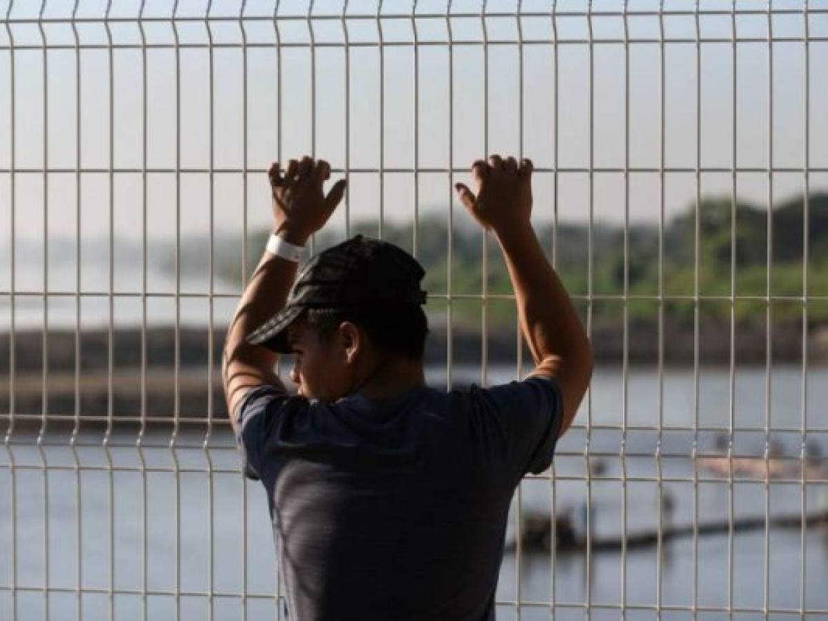 Un joven hondureño migrante que se dirige a EE.UU. en la segunda caravana de este año permanece en la frontera entre México y Guatemala. Foto JOHAN ORDONEZ / AFP