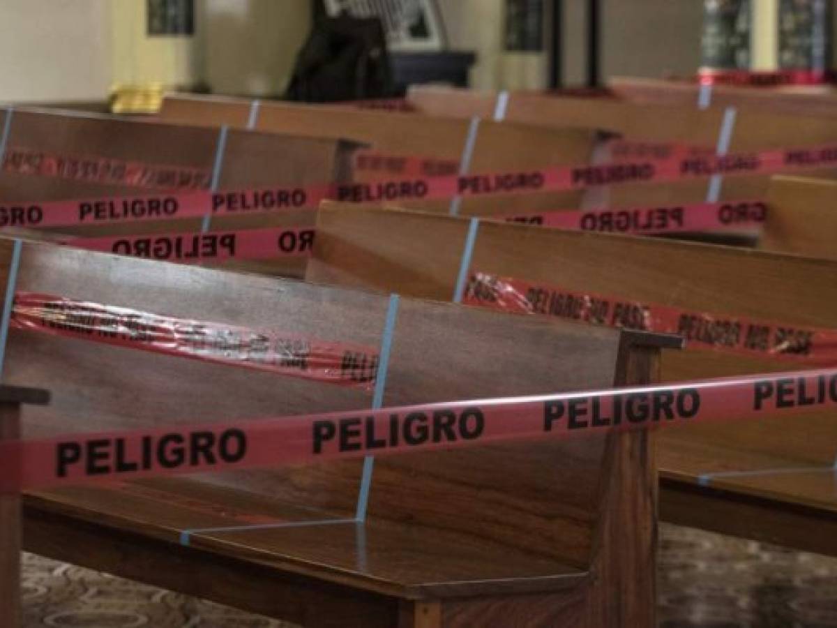 View of empty pews with tape reading Danger at the Basilica de los Angeles in Cartago, Costa Rica, June 28, 2020, amid the new coronavirus pandemic. - The third phase of measures against the spread of COVID-19 began Sunday in Costa Rica, allowing assistance to churches with a minimum distance of 1.8 meters between each person and with a maximum of 75 people, all with masks. (Photo by Ezequiel BECERRA / AFP)