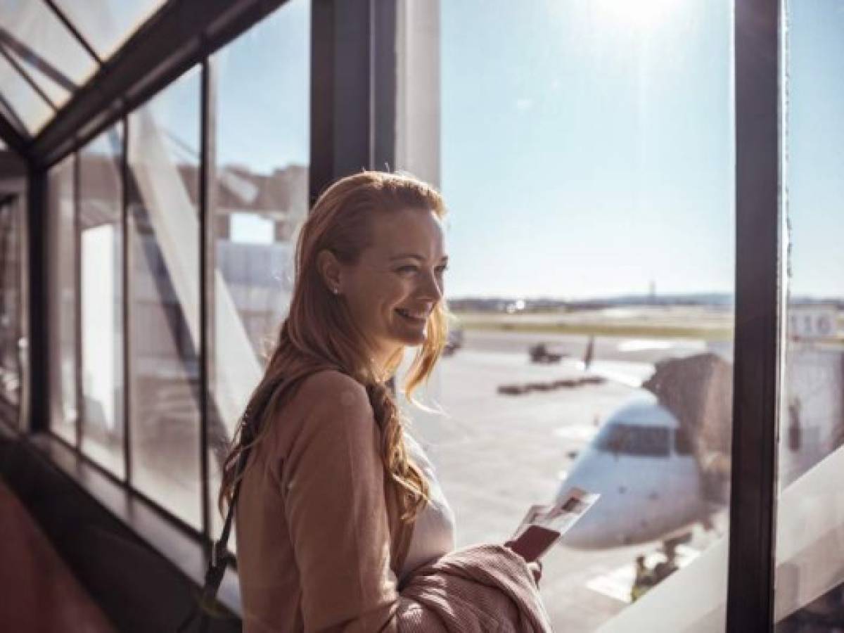 Close up of a young woman waiting to board the airplane at the airport
