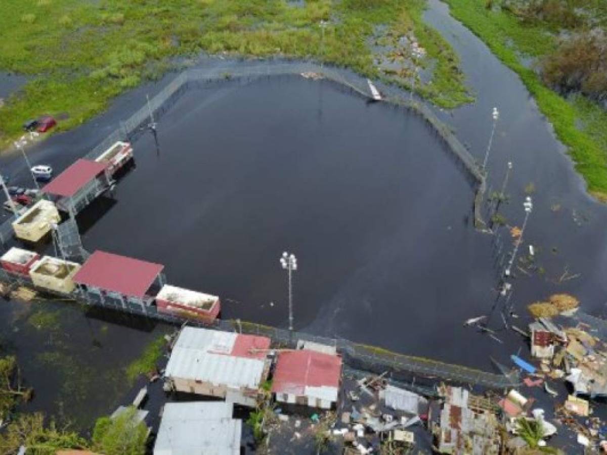 An aerial view shows the flooded neighbourhood of Juana Matos in the aftermath of Hurricane Maria in Catano, Puerto Rico, on September 22, 2017.Puerto Rico battled dangerous floods Friday after Hurricane Maria ravaged the island, as rescuers raced against time to reach residents trapped in their homes and the death toll climbed to 33. Puerto Rico Governor Ricardo Rossello called Maria the most devastating storm in a century after it destroyed the US territory's electricity and telecommunications infrastructure. / AFP PHOTO / Ricardo ARDUENGO