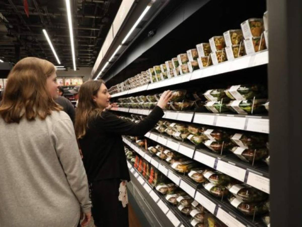 NEW YORK, NEW YORK - MAY 07: People shop at the newly opened Amazon Go Store on May 07, 2019 in New York City. The cashier-less store, the first of this type of store, called Amazon Go, accepts cash and is the 12th such store in the United States located at Brookfield Place in downtown New York. The roughly 1,300-square-foot store sells a variety of food items, prepared meals and Amazon's own meal kits. It is believed that by 2021 Amazon is considering opening up as many as 3,000 of its cashier-free stores across the United States. Spencer Platt/Getty Images/AFP