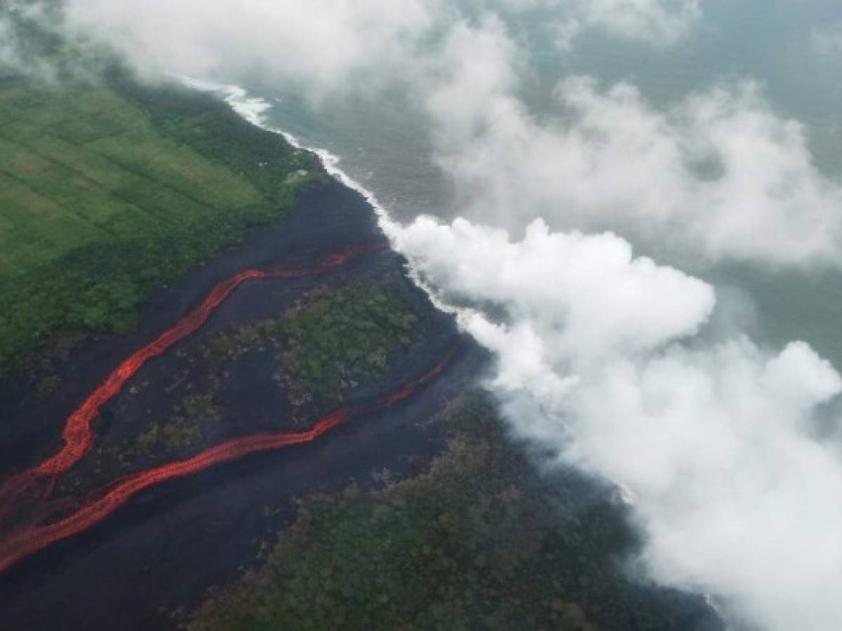 PAHOA, HI - MAY 21: Steam plumes rise as lava enters the Pacific Ocean, after flowing to the water from a Kilauea volcano fissure, on Hawaii's Big Island on May 21, 2018 near Pahoa, Hawaii. Officials are concerned that 'laze', a dangerous product produced when hot lava hits cool ocean water, will affect residents. Laze, a word combination of lava and haze, contains hydrochloric acid steam along with volcanic glass particles. Mario Tama/Getty Images/AFP PAHOA, HI - MAY 21: Steam plumes rise as lava enters the Pacific Ocean, after flowing to the water from a Kilauea volcano fissure, on Hawaii's Big Island on May 21, 2018 near Pahoa, Hawaii. Officials are concerned that 'laze', a dangerous product produced when hot lava hits cool ocean water, will affect residents. Laze, a word combination of lava and haze, contains hydrochloric acid steam along with volcanic glass particles. Mario Tama/Getty Images/AFP