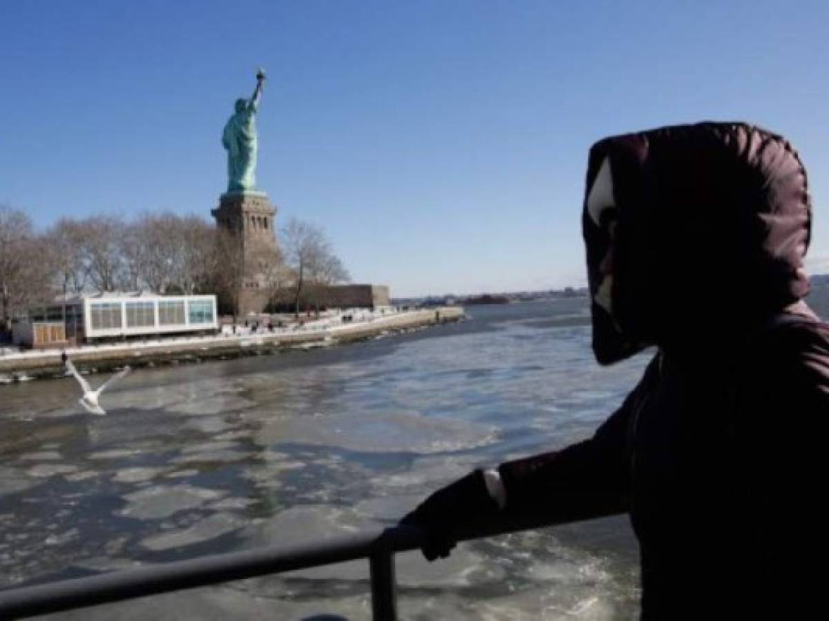 NEW YORK, NY - JANUARY 06: People ride the ferry to visit the Statue of Liberty while ice floats along the Hudson River during freezing temperatures on January 06, 2018 in New York City. The extreme conditions suffered across the United States are a result of the 'bomb cyclone' brought along by Storm Grayson. Eduardo Munoz Alvarez/Getty Images/AFP
