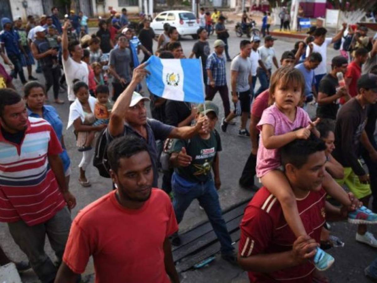 A migrant -alongside other Central Americans taking part in a caravan called 'Migrant Viacrucis' towards the United States- holds a Guatemalan national flag during a march to protest against US President Donald Trump's policies in Matias Romero, Oaxaca State, Mexico, on April 3, 2018. The hundreds of Central Americans in the 'Way of the Cross' migrant caravan have infuriated Trump, but they are not moving very fast -- if at all -- and remain far from the US border. As Trump vowed Tuesday to send troops to secure the southern US border, the caravan was camped out for the third straight day in the town of Matias Romero, in southern Mexico, more than 3,000 kilometers (1,800 miles) from the United States. / AFP PHOTO / VICTORIA RAZO