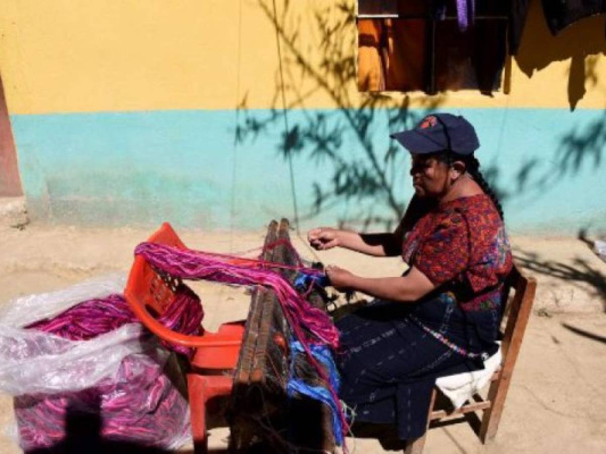 Catarina Tzoc weaves fabric rolls inspired by Mayan costumes for the making of reusable bags, in an attempt to put a curb on the abuse of plastic usage, in Nahuala municipality, Solola departament 85 km west of Guatemala City, on February 16, 2018. / AFP PHOTO / JOHAN ORDONEZ / TO GO WITH AFP STORY by HENRY MORALES ARANA