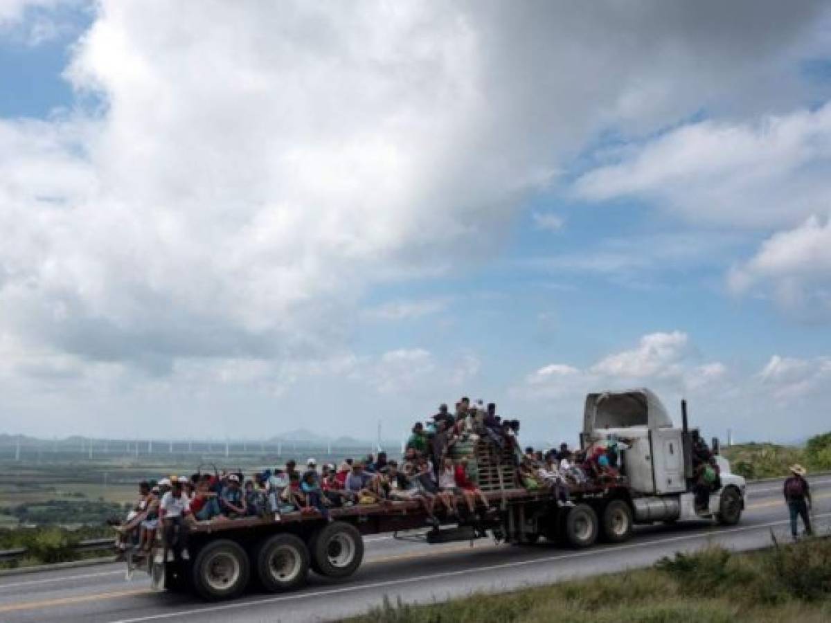 HIDALGO, TEXAS - MARCH 25: Asylum seekers await transport by U.S. Border Patrol agents after their group of immigrants crossed the Rio Grande into Texas on March 25, 2021 in Hidalgo, Texas. A large group of families and unaccompanied minors came across from Mexico onto private property before being taken into custody by border agents. John Moore/Getty Images/AFP== FOR NEWSPAPERS, INTERNET, TELCOS & TELEVISION USE ONLY ==