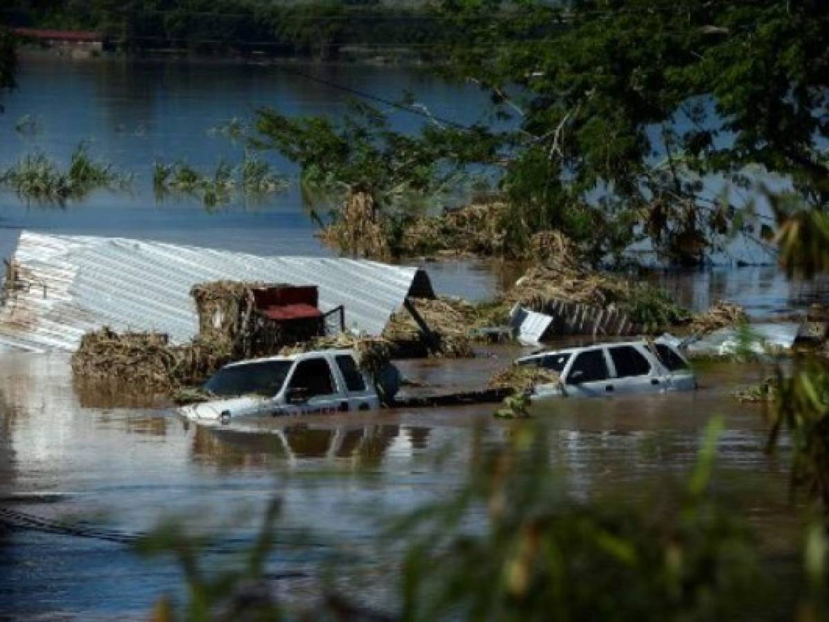 View of the flooded road to San Pedro Sula, following the passage of Hurricane Eta, near the locality of Campin, 240km north of Tegucigalpa, on November 7, 2020. - Scores of people have died or remain unaccounted for as the remnants of Hurricane Eta unleashed floods and triggered landslides on its deadly march across Central America. (Photo by Orlando SIERRA / AFP)