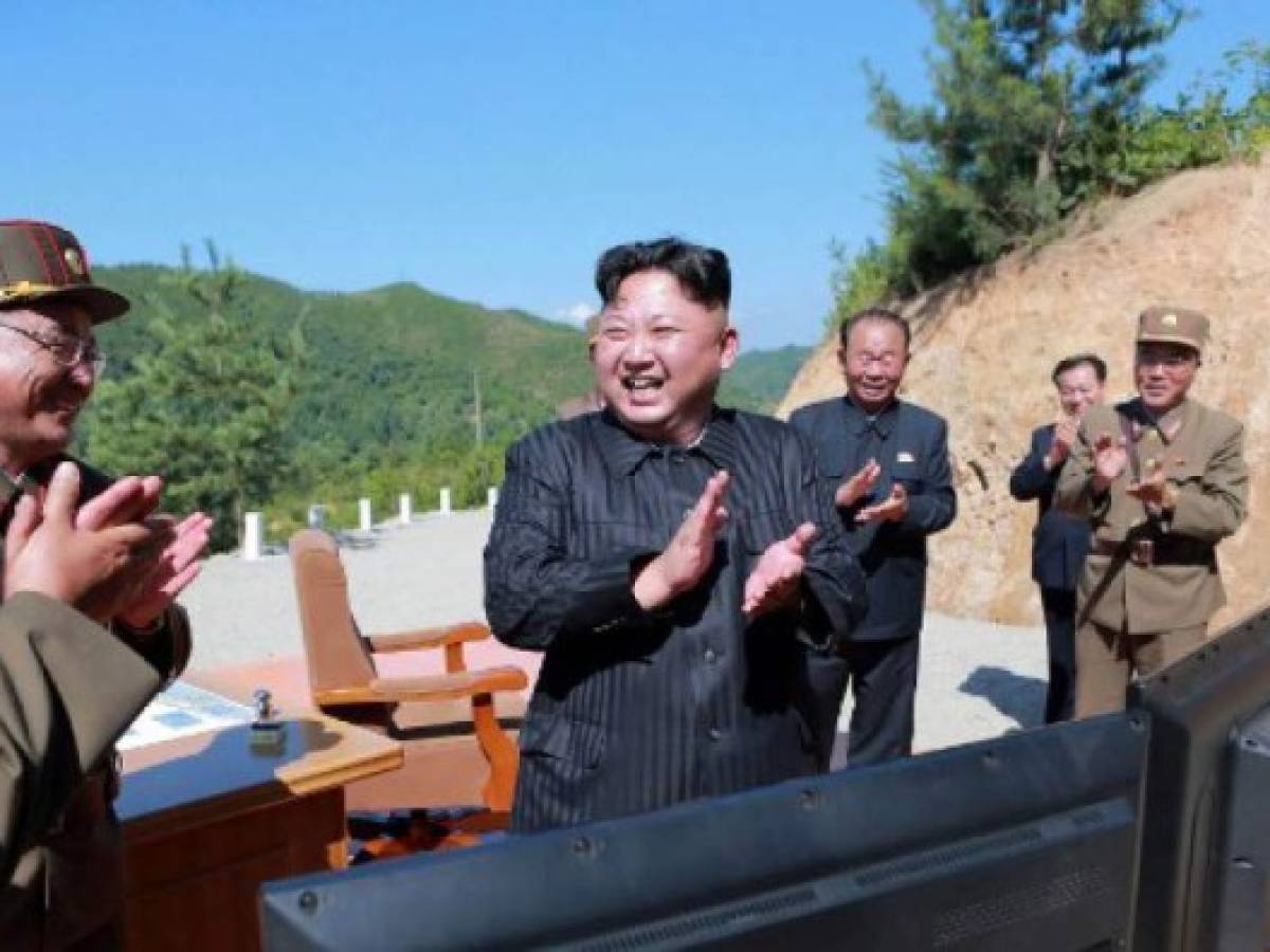 (FILES) This file photo released on July 5, 2017 by North Korea's official Korean Central News Agency (KCNA) shows North Korean leader Kim Jong-Un (C) celebrating the successful test-fire of the intercontinental ballistic missile Hwasong-14 at an undisclosed location.A rocket launched by North Korea was an intercontinental ballistic missile (ICBM) that flew about 1,000 kilometers (620 miles) before splashing down in the Sea of Japan, the Pentagon said on November 28, 2017. According to an initial assessment, the missile was launched from Sain Ni in North Korea and flew within Japan's Economic Exclusion Zone (EEZ). / AFP PHOTO / KCNA VIA KNS / STR / South Korea OUT / REPUBLIC OF KOREA OUT ---EDITORS NOTE--- RESTRICTED TO EDITORIAL USE - MANDATORY CREDIT 'AFP PHOTO/KCNA VIA KNS' - NO MARKETING NO ADVERTISING CAMPAIGNS - DISTRIBUTED AS A SERVICE TO CLIENTSTHIS PICTURE WAS MADE AVAILABLE BY A THIRD PARTY. AFP CAN NOT INDEPENDENTLY VERIFY THE AUTHENTICITY, LOCATION, DATE AND CONTENT OF THIS IMAGE. THIS PHOTO IS DISTRIBUTED EXACTLY AS RECEIVED BY AFP. /
