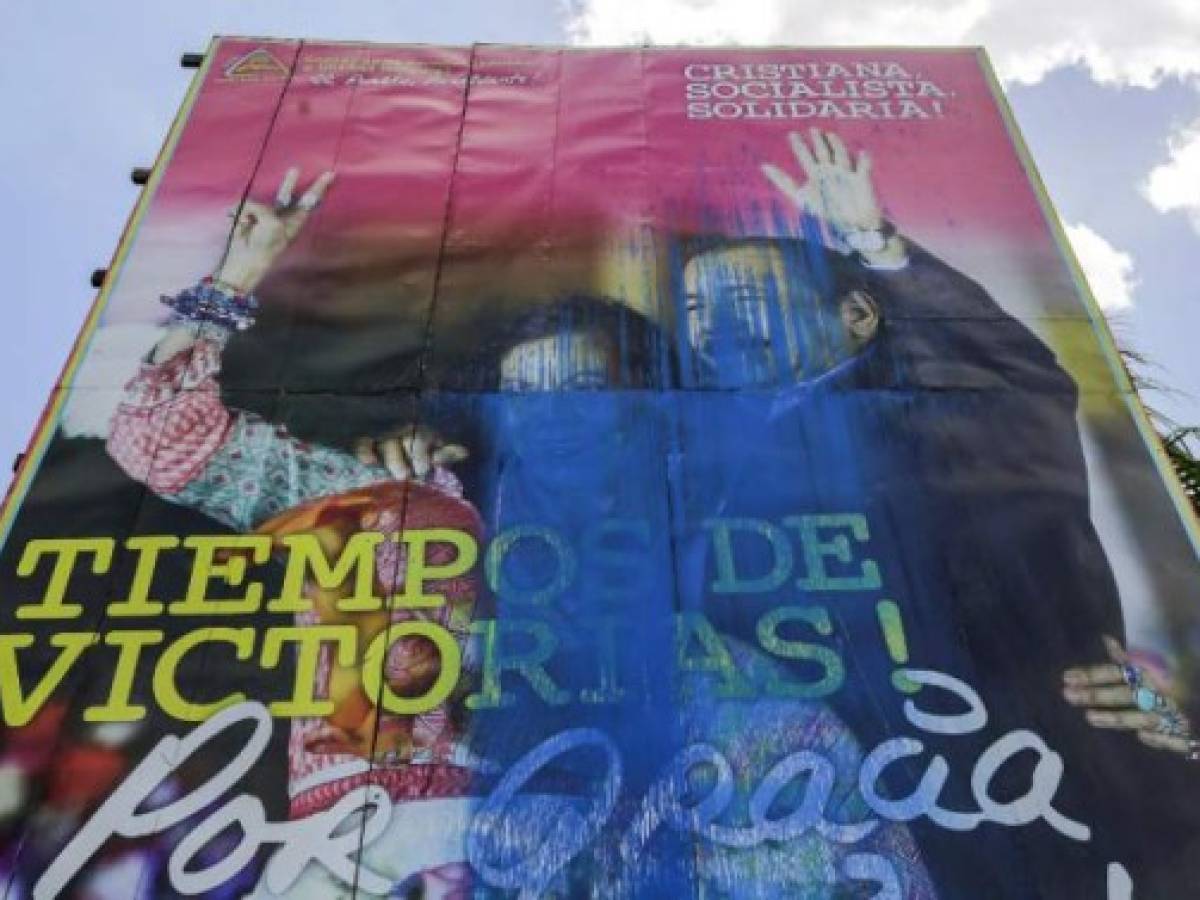 View of a vandalized billboard supporting Nicaragua's President Daniel Ortega and his wife and Vice President Rosario Murillo n Managua on May 16, 2018.President Daniel Ortega opened talks with opposition groups in a bid to quell a month of anti-government unrest that has seen more than 50 people killed. The Church-mediated dialogue involved representatives from university students who are leading the protests as well as from business groups and unions. / AFP PHOTO / INTI OCON