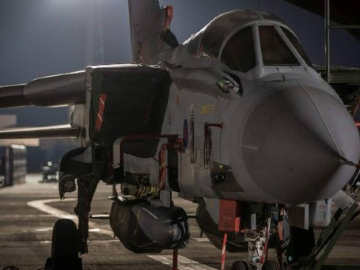 In a handout picture released by the British Ministry of Defence (MOD) on April 14, 2018 a Royal Air Force (RAF) Tornado GR4 aircraft sits on the pan with two Storm Shadows missiles underneath it before taking off from the British base RAF Akrotiri in Cyprus on April 14, 2018 as part of a mission to conduct strikes in support of Operations in Syria. The United States, Britain and France carried out a wave of pre-dawn strikes against Syria's regime on April 14, 2018 in response to a suspected chemical weapons attack, lighting up the sky of Damascus as explosions shook the city. / AFP PHOTO / MOD / Cpl L Matthews / RESTRICTED TO EDITORIAL USE - MANDATORY CREDIT ' AFP PHOTO / CROWN COPYRIGHT 2018 / MOD / CPL L MATTHEWS ' - NO MARKETING NO ADVERTISING CAMPAIGNS - DISTRIBUTED AS A SERVICE TO CLIENTS - NO ARCHIVE - TO BE USED WITHIN 2 DAYS FROM APRIL 14, 2018 (48 HOURS), EXCEPT FOR MAGAZINES WHICH CAN PRINT THE PICTURE WHEN FIRST REPORTING ON THE EVENT / In a handout picture released by the British Ministry of Defence (MOD) on April 14, 2018 a Royal Air Force (RAF) Tornado GR4 aircraft sits on the pan with two Storm Shadows missiles underneath it before taking off from the British base RAF Akrotiri in Cyprus on April 14, 2018 as part of a mission to conduct strikes in support of Operations in Syria. The United States, Britain and France carried out a wave of pre-dawn strikes against Syria's regime on April 14, 2018 in response to a suspected chemical weapons attack, lighting up the sky of Damascus as explosions shook the city. / AFP PHOTO / MOD / Cpl L Matthews / RESTRICTED TO EDITORIAL USE - MANDATORY CREDIT ' AFP PHOTO / CROWN COPYRIGHT 2018 / MOD / CPL L MATTHEWS ' - NO MARKETING NO ADVERTISING CAMPAIGNS - DISTRIBUTED AS A SERVICE TO CLIENTS - NO ARCHIVE - TO BE USED WITHIN 2 DAYS FROM APRIL 14, 2018 (48 HOURS), EXCEPT FOR MAGAZINES WHICH CAN PRINT THE PICTURE WHEN FIRST REPORTING ON THE EVENT /