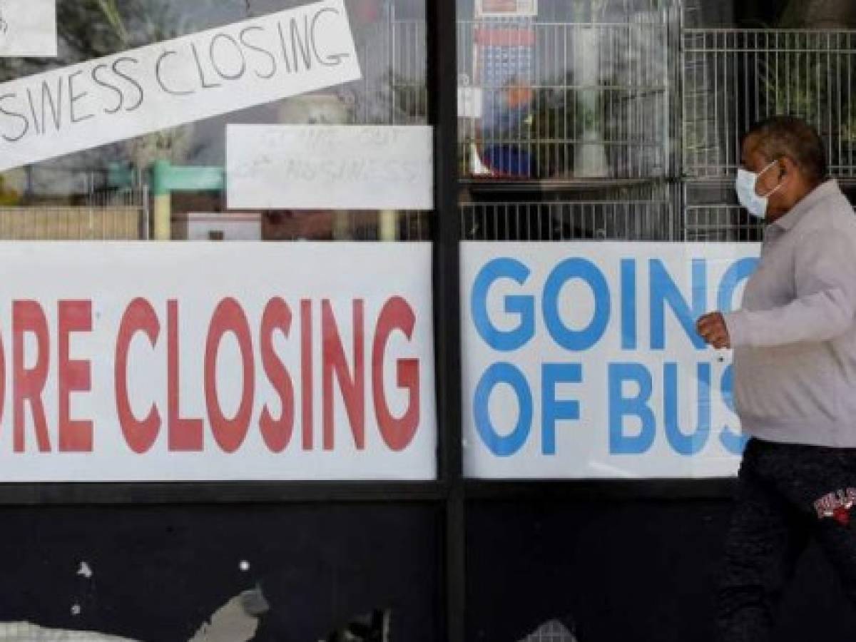 FILE - In this May 21, 2020 file photo, a man looks at signs of a closed store due to COVID-19 in Niles, Ill. U.S. businesses shed 2.76 million jobs in May, as the economic damage from the historically unrivaled coronavirus outbreak stretched into a third month. The payroll company ADP reported Wednesday that businesses have let go of a combined 22.6 million jobs since March.AP Photo/Nam Y. Huh, File) FILE - In this May 21, 2020 file photo, a man looks at signs of a closed store due to COVID-19 in Niles, Ill. U.S. businesses shed 2.76 million jobs in May, as the economic damage from the historically unrivaled coronavirus outbreak stretched into a third month. The payroll company ADP reported Wednesday that businesses have let go of a combined 22.6 million jobs since March.AP Photo/Nam Y. Huh, File)