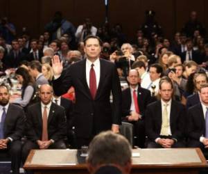 WASHINGTON, DC - JUNE 08: Former FBI Director James Comey is sworn-in before testifing before the Senate Intelligence Committee in the Hart Senate Office Building on Capitol Hill June 8, 2017 in Washington, DC. Comey said that President Donald Trump pressured him to drop the FBI's investigation into former National Security Advisor Michael Flynn and demanded Comey's loyalty during the one-on-one meetings he had with president. Mark Wilson/Getty Images/AFP