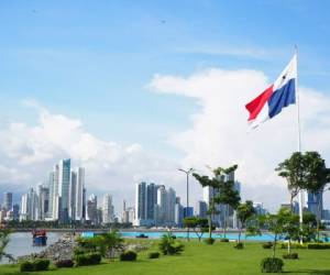 Panama city centre park with a flag and ocean.